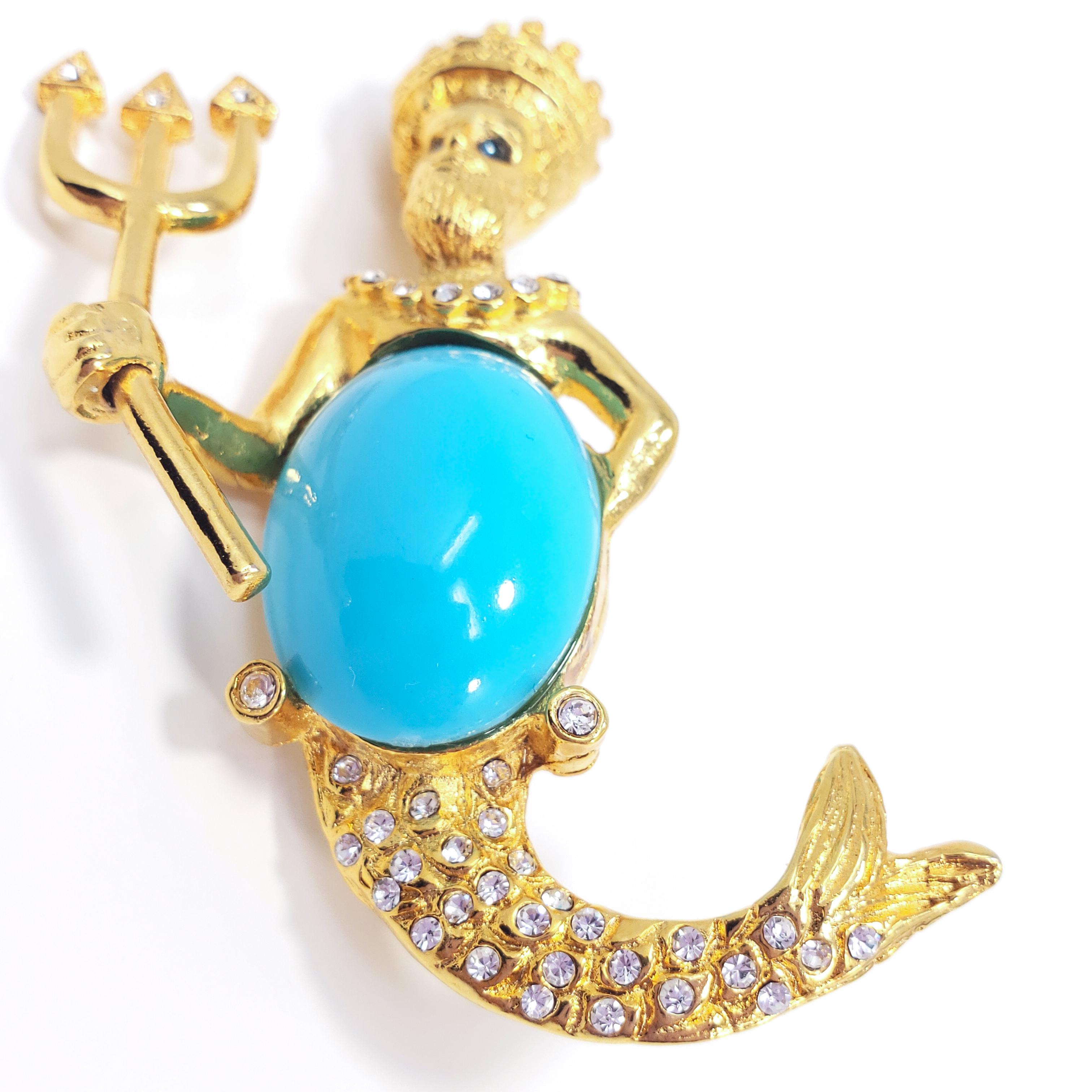 Kenneth Jay Lane's fierce Poseidon/Neptune brooch, featuring a crystal-encrusted, gold-tone Poseidon wearing a crown and holding a trident and faux-turquoise cabochon shield.

Hallmarks: Kenneth © Lane, Made in USA

