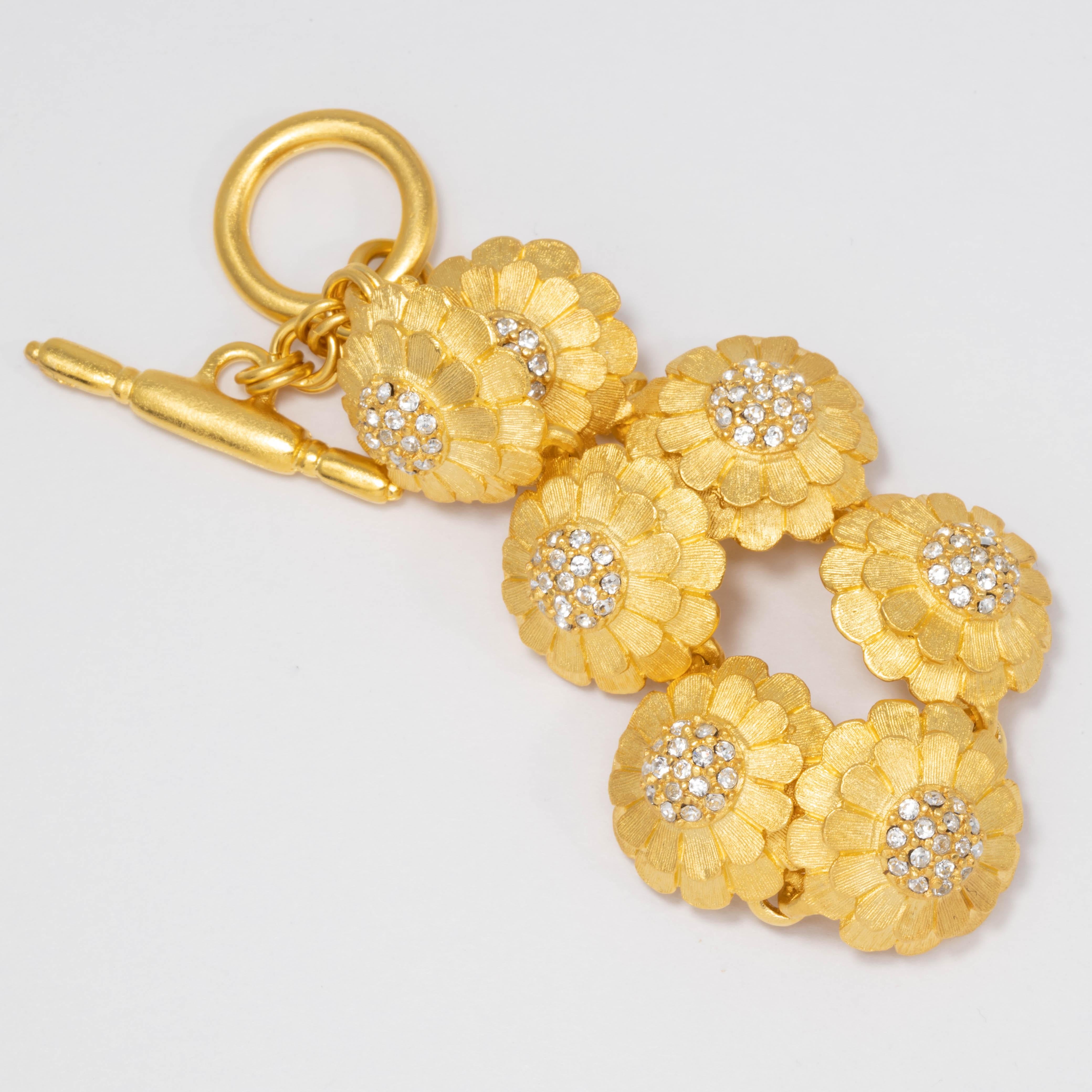 A glowing gold feminine touch! Blooming flowers in glowing satin gold and sparkling crystals, linked together to elevate your look.

Bracelet by Kenneth Jay Lane. Toggle clasp. Gold plated.

Tags, Marks, Hallmarks: KJL