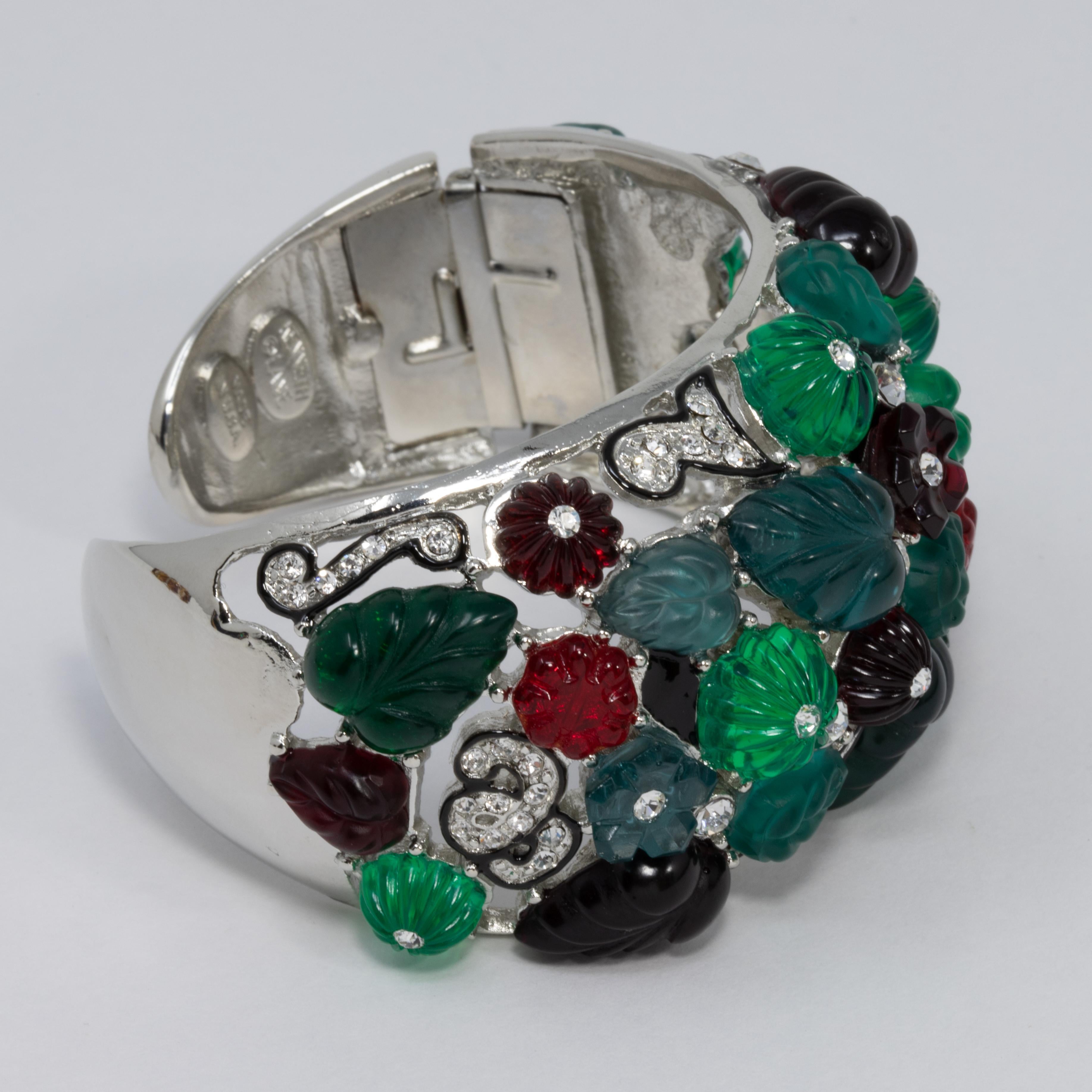 Bracelet by Kenneth Jay Lane. Tutti frutti resin motifs in green, red, and blue accented with clear crystals. Set on rhodium plating.

Hallmarks: Kenneth Lane, Made in USA

Inner diameter at widest part 5.8cm
Inner circumference 16cm