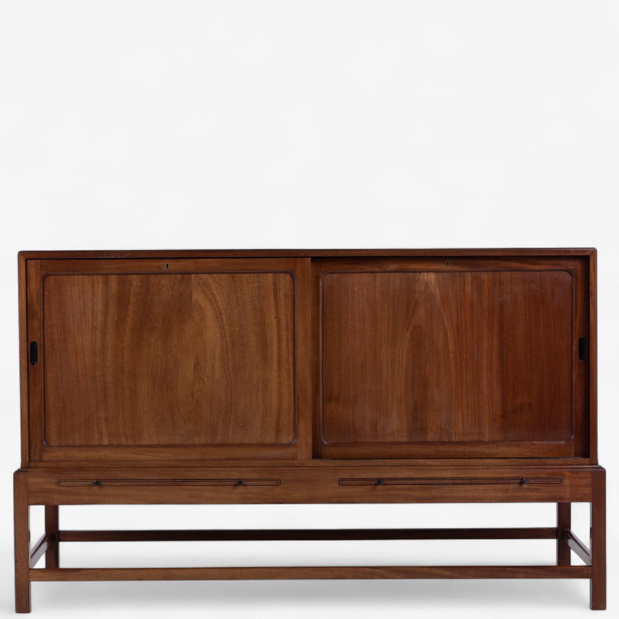 KK 4122 - Sideboard in Cuba mahogany with two sliding doors, pull-out shelves and brass handles. Designed in 1930 by Kaare Klint. Labelled from manufacturer Rud Rasmussen Snedkerier.