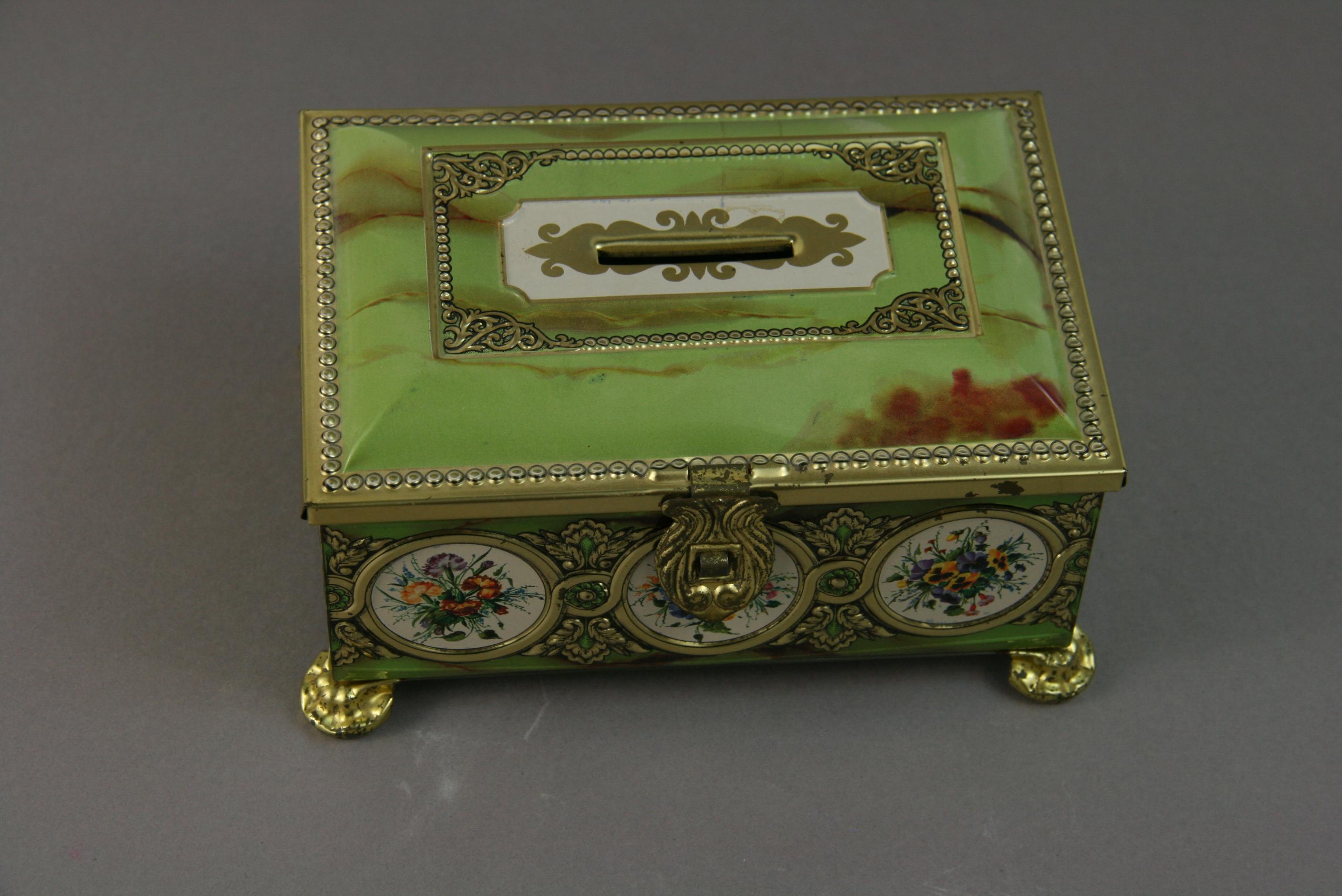 3-375 tin container /bank green gold floral detailing with gilt feet
Made by Klann in Western Germany.
Other similar boxes available different colors