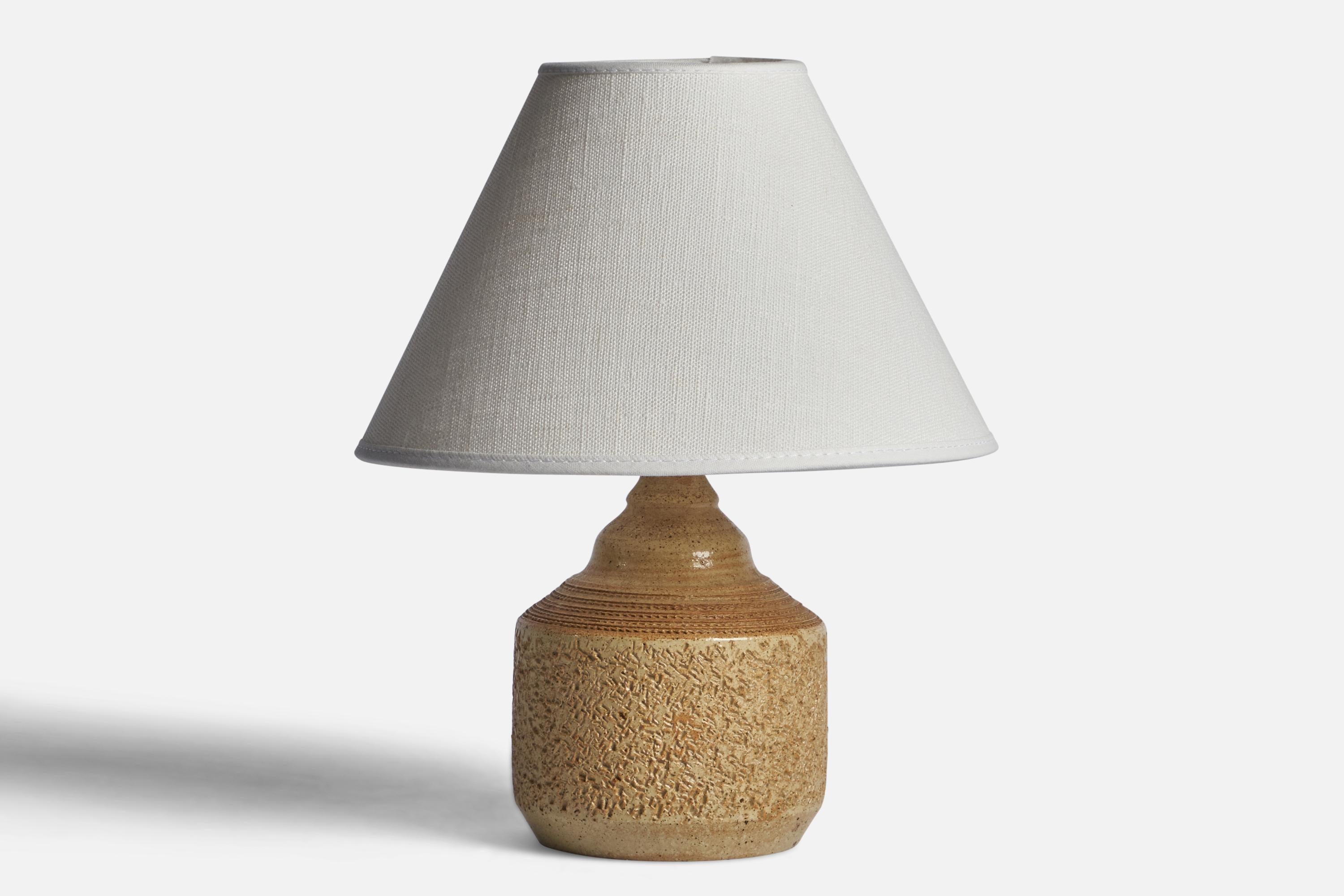A small brown and beige-glazed stoneware table lamp designed and produced by Klas Svensson, Höganäs, Sweden, c. 1960s.

Dimensions of Lamp (inches): 7.25” H x 3.9” Diameter
Dimensions of Shade (inches): 3” Top Diameter x 8” Bottom Diameter x 5” H