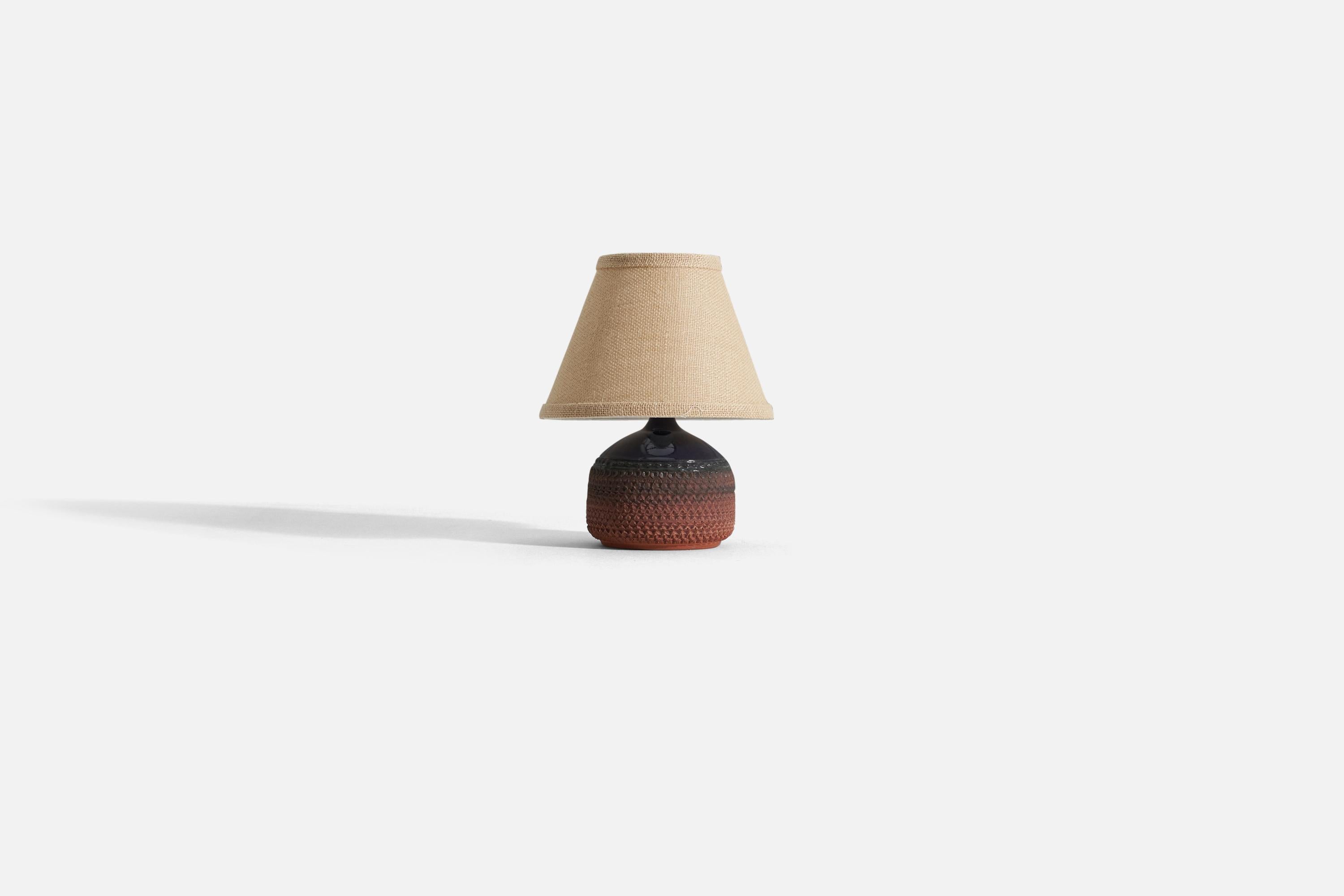 A black and red stoneware table lamp with simple incised decor by Klase Höganäs. Stamped.

Measurements listed are of the lamp itself. Sold without lampshade.
For reference:
Measurements of shade (inches): 4.25 x 8.25 x 6 (T x B x S)
Overall