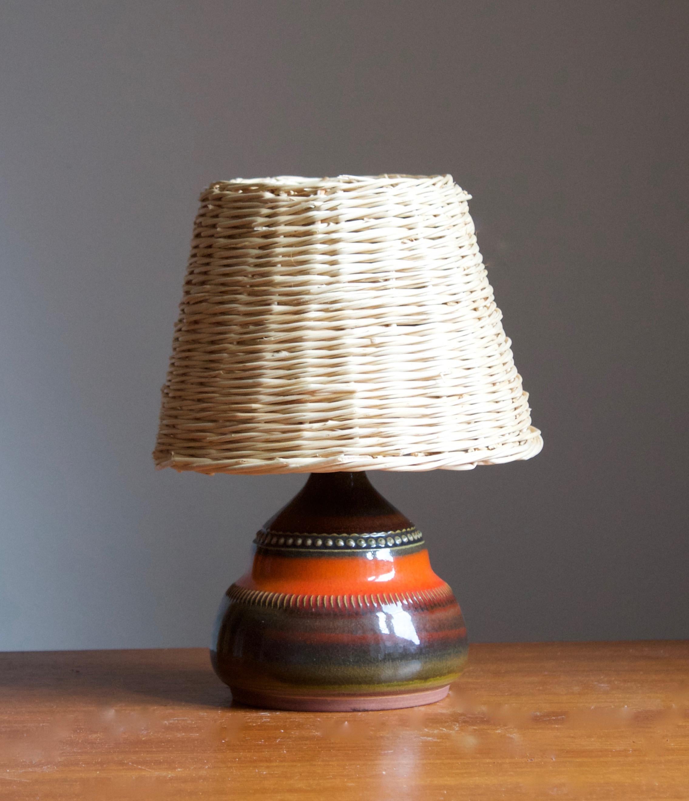 A table lamp by Klase Höganäs. In stoneware with simple incised decor. Signed. 

Dimensions stated exclude lampshade. Height includes socket. Vintage rattan lampshade of illustrated model can be included upon request.

Glaze features