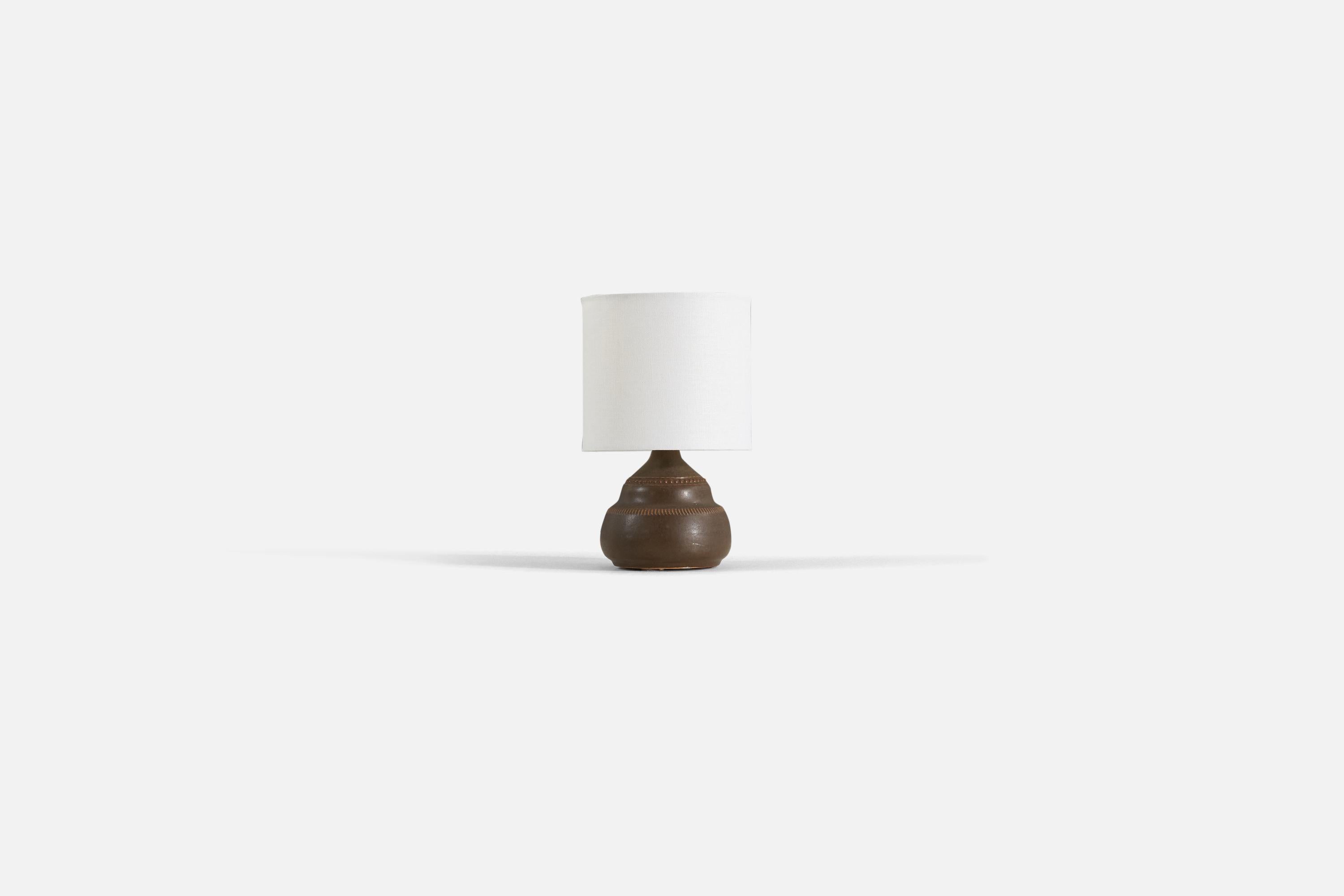 A brown glazed stoneware table lamp produced by Klase Höganäs, Sweden, 1960s.

Sold without lampshade. 

Measurements listed are of lamp.
Shade : 6 x 6 x 5.5
Lamp with shade : 9.75 x 6 x 6.