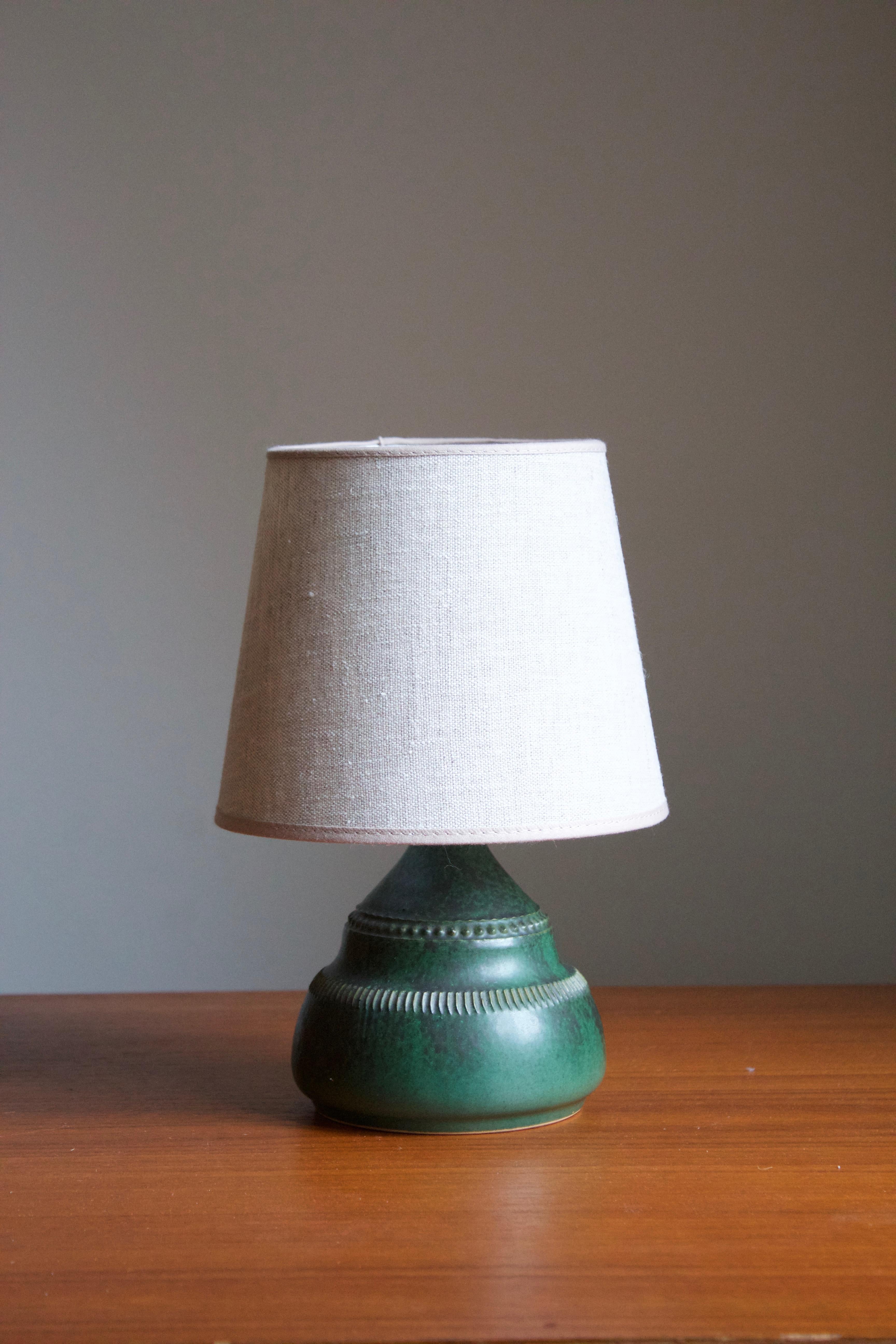 A table lamp by Klase Höganäs. In stoneware. Signed. With brand new high-end linen lampshade. 

  