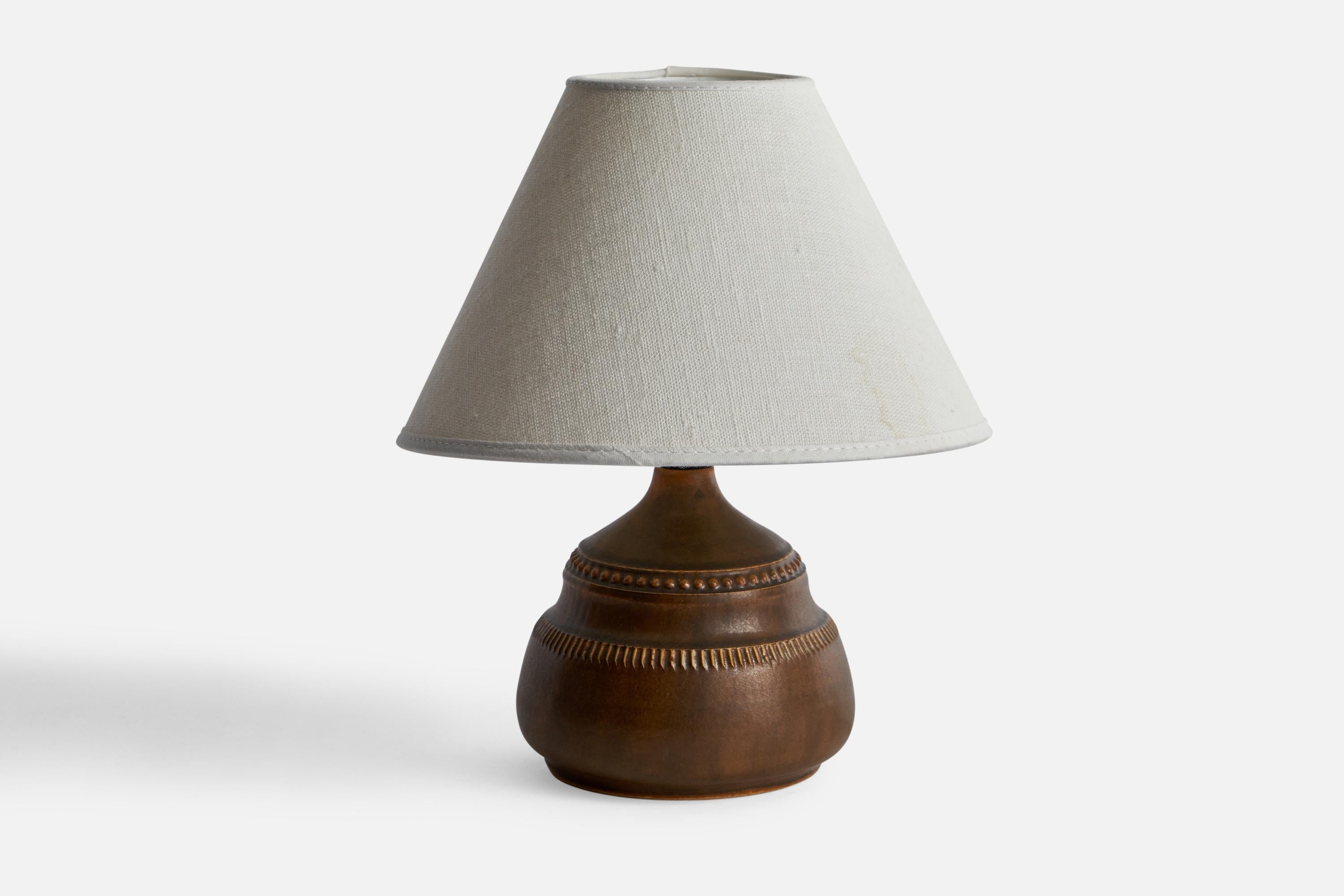 A brown-glazed stoneware table lamp designed and produced by Klase Höganäs, Sweden, 1960s.

Dimensions of Lamp (inches): 6.25” H x 4.63” Diameter
Dimensions of Shade (inches): 3” Top Diameter x 8” Bottom Diameter x 5” H
Dimensions of Lamp with Shade