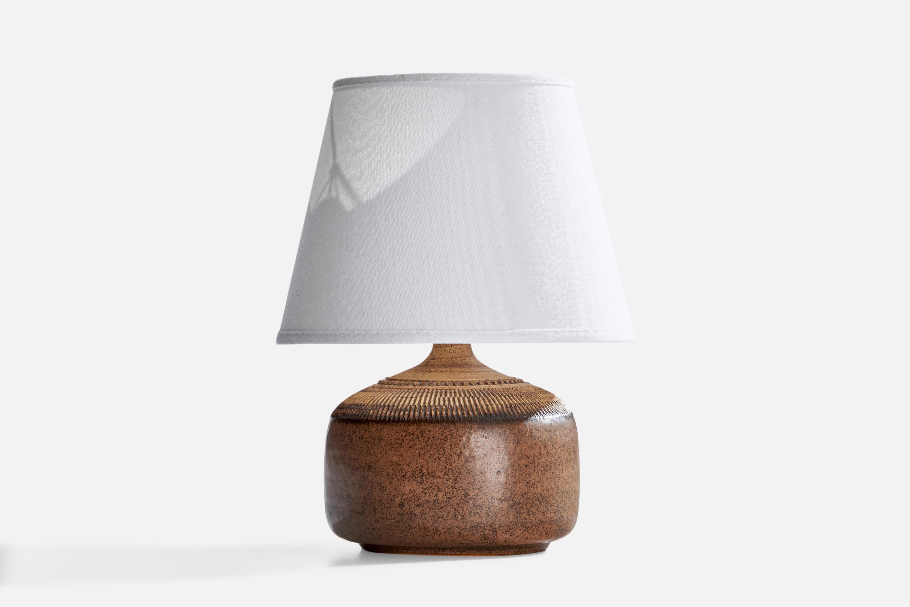 A brown-glazed stoneware table lamp produced by Klase Höganäs, Sweden, c. 1970s.

Dimensions of Lamp (inches): 7” H x 5.5” Diameter
Dimensions of Shade (inches): 5” Top Diameter x 8” Bottom Diameter x 6” H
Dimensions of Lamp with Shade (inches): 10”