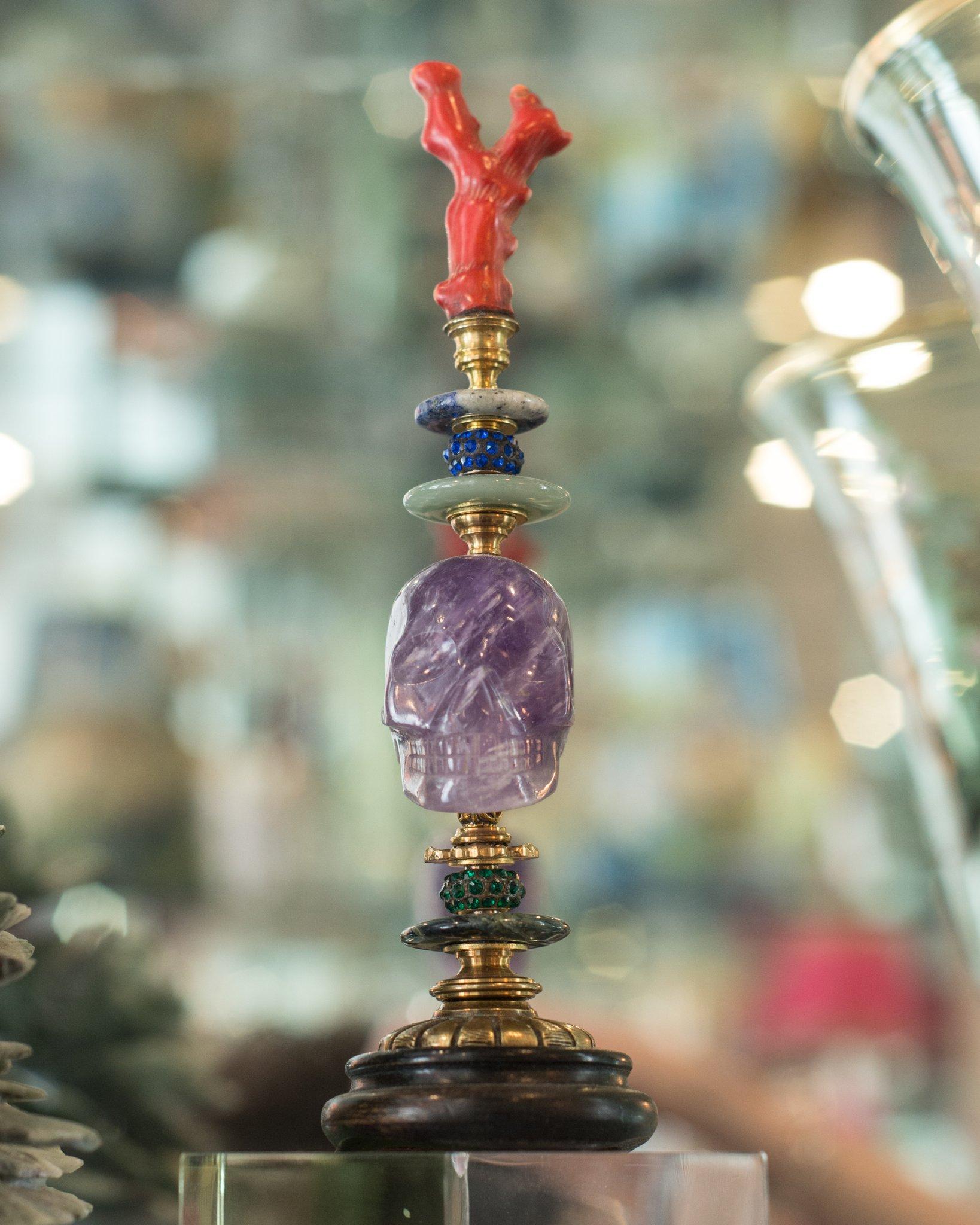 A one of a kind sculptural objet consisting of a carved amethyst skull with an authentic coral branch, semi-precious stones and antique bronze components on a painted wood pedestal by German artist, Dupont.

Klaus Dupont’s stylistically unique