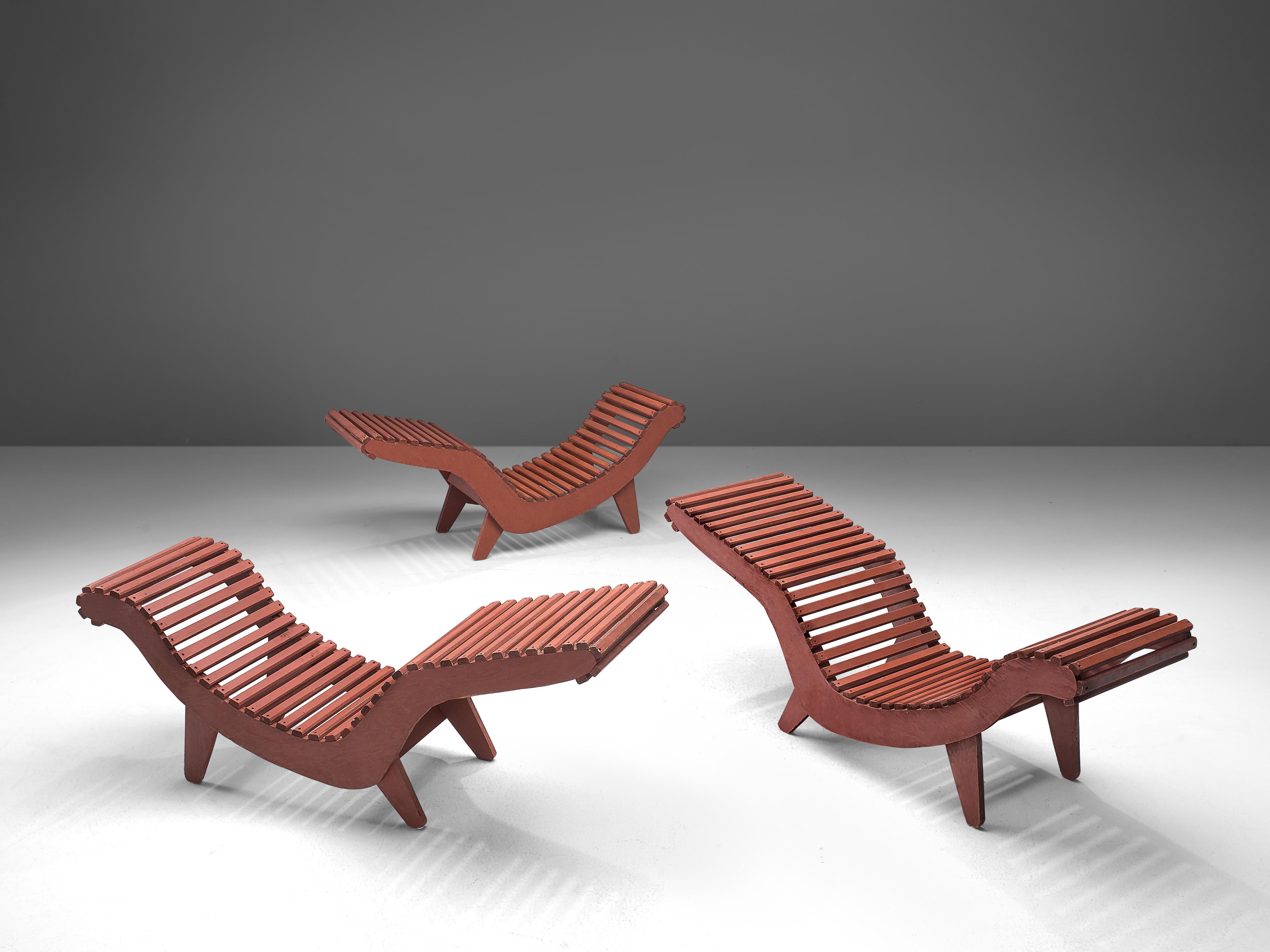 Lounge chairs 'C5', deep red wood, plywood, United States, 1950s.

These three red wooden slat ‘C5’ chaise longues from the 1950s were designed by Klaus Grabe. The core of this design is the curvaceous plywood frame. Plywood was a new material and