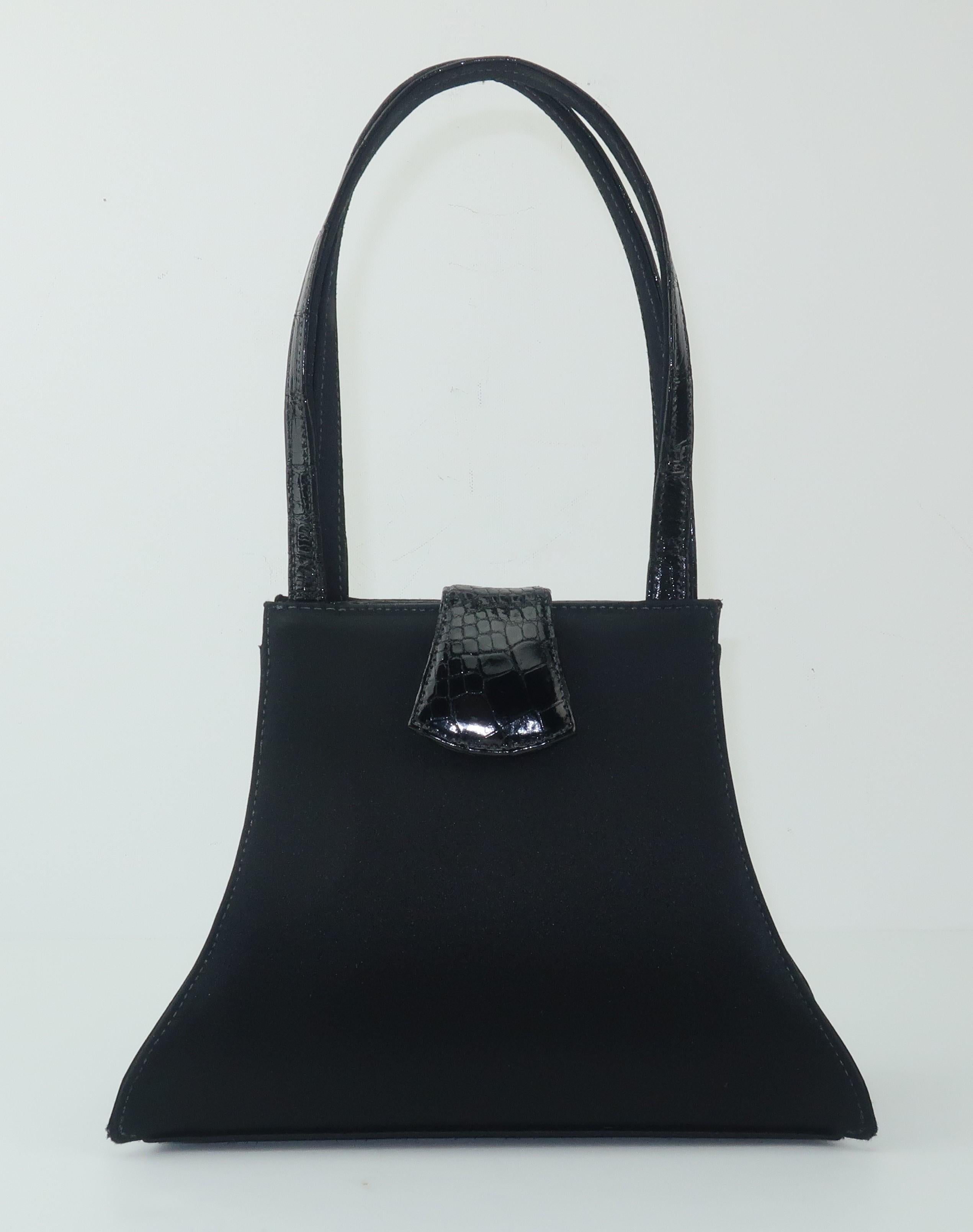 Clever combination of a classic black satin evening handbag with the unexpected addition of alligator details from the designers at Kleinberg Sherrill (now doing business as W. Kleinberg) specialists in luxury goods fabricated from exotic skins