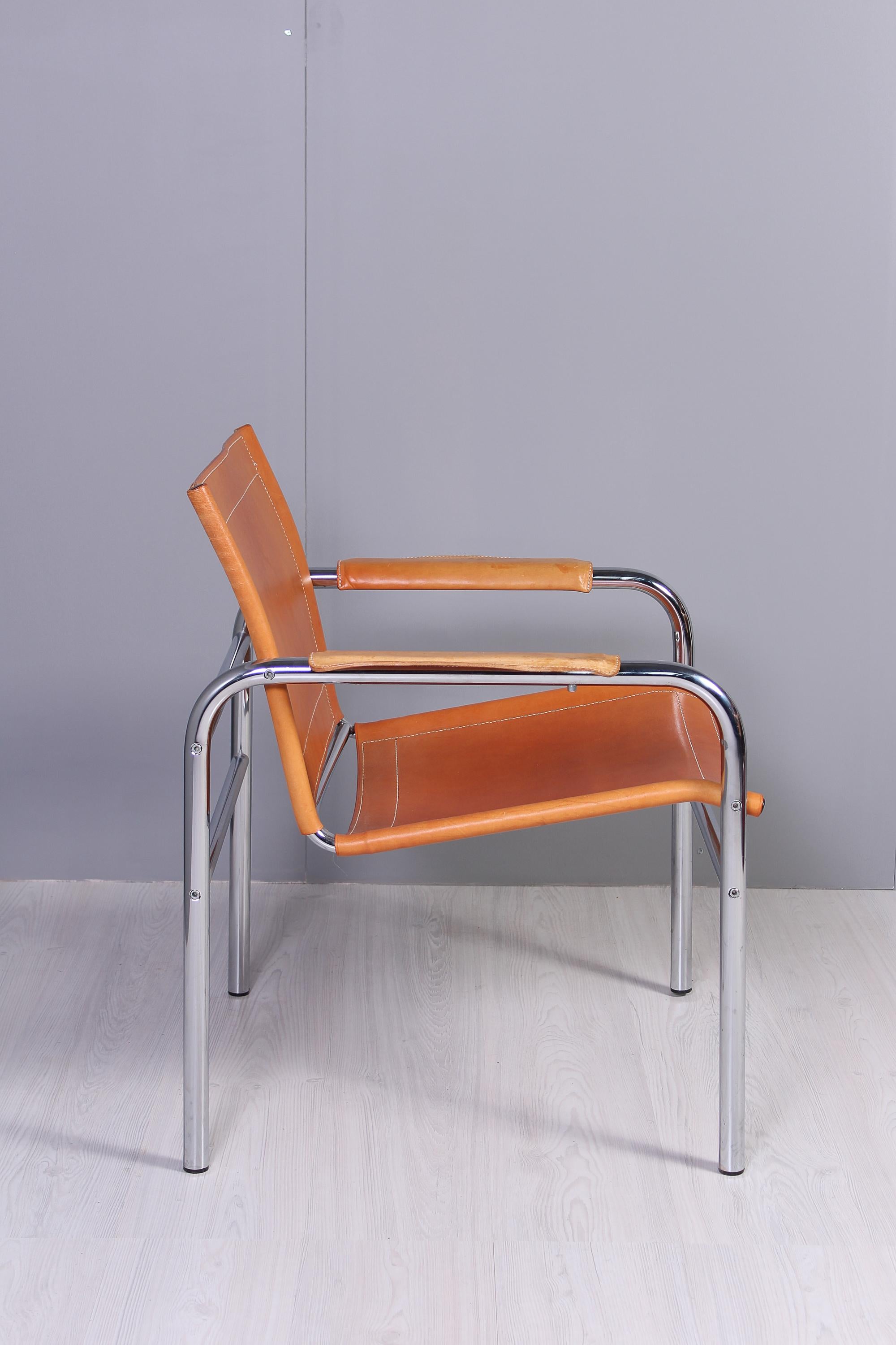 This chair is designed by Swedish designer Tord Björklund and was produced by Ikea in the 1970s. The chair has a thick cognac brown leather upholstery and a chrome steel frame. The leather is in excellent vintage condition with just the right amount