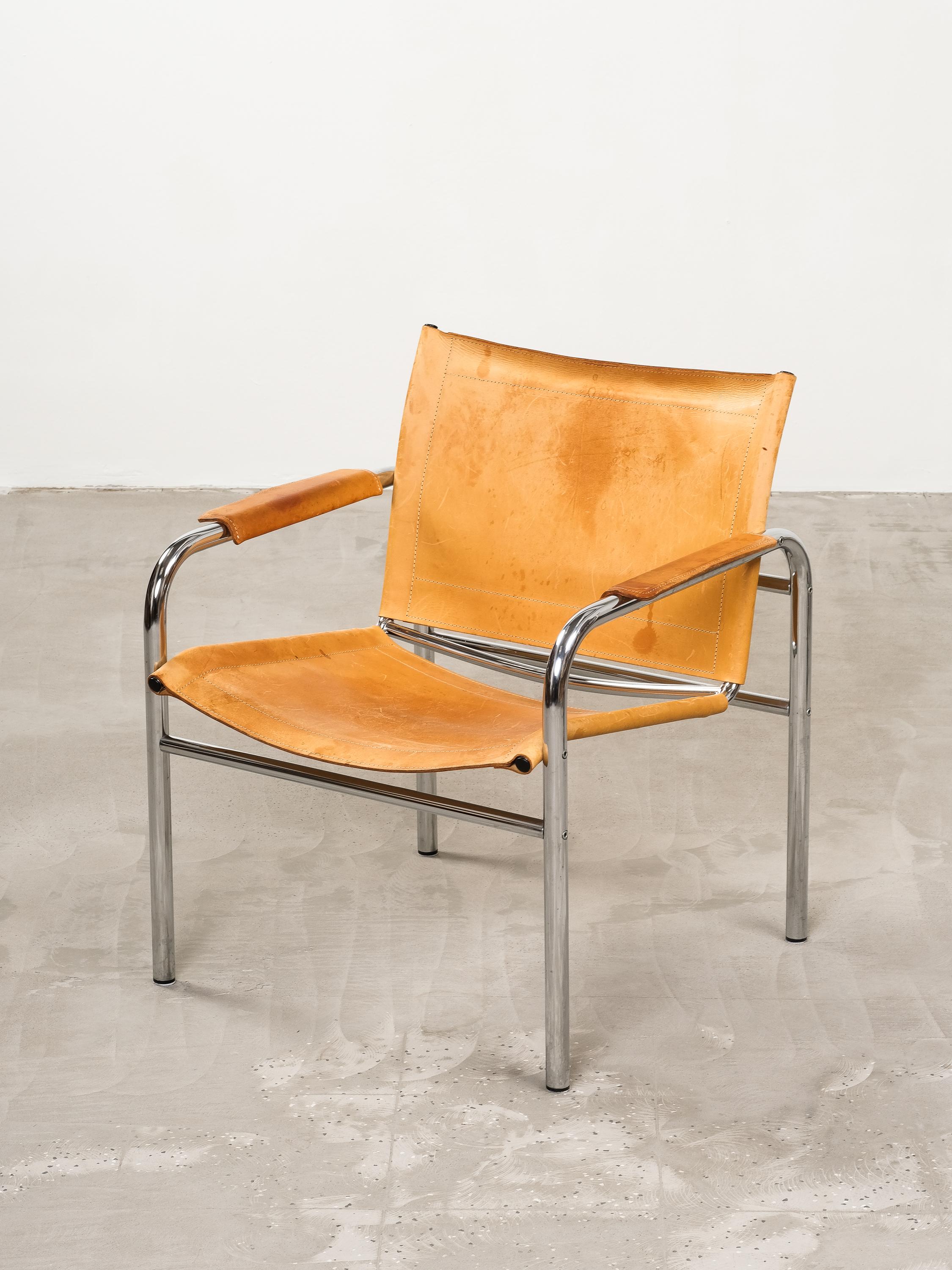 Vintage Ikea easy chair designed by Tord Björklund around 1980. This comes with the original patinated natural leather upholstery which has aged beautifully. Combined with a chromed tubular steel frame in great condition.