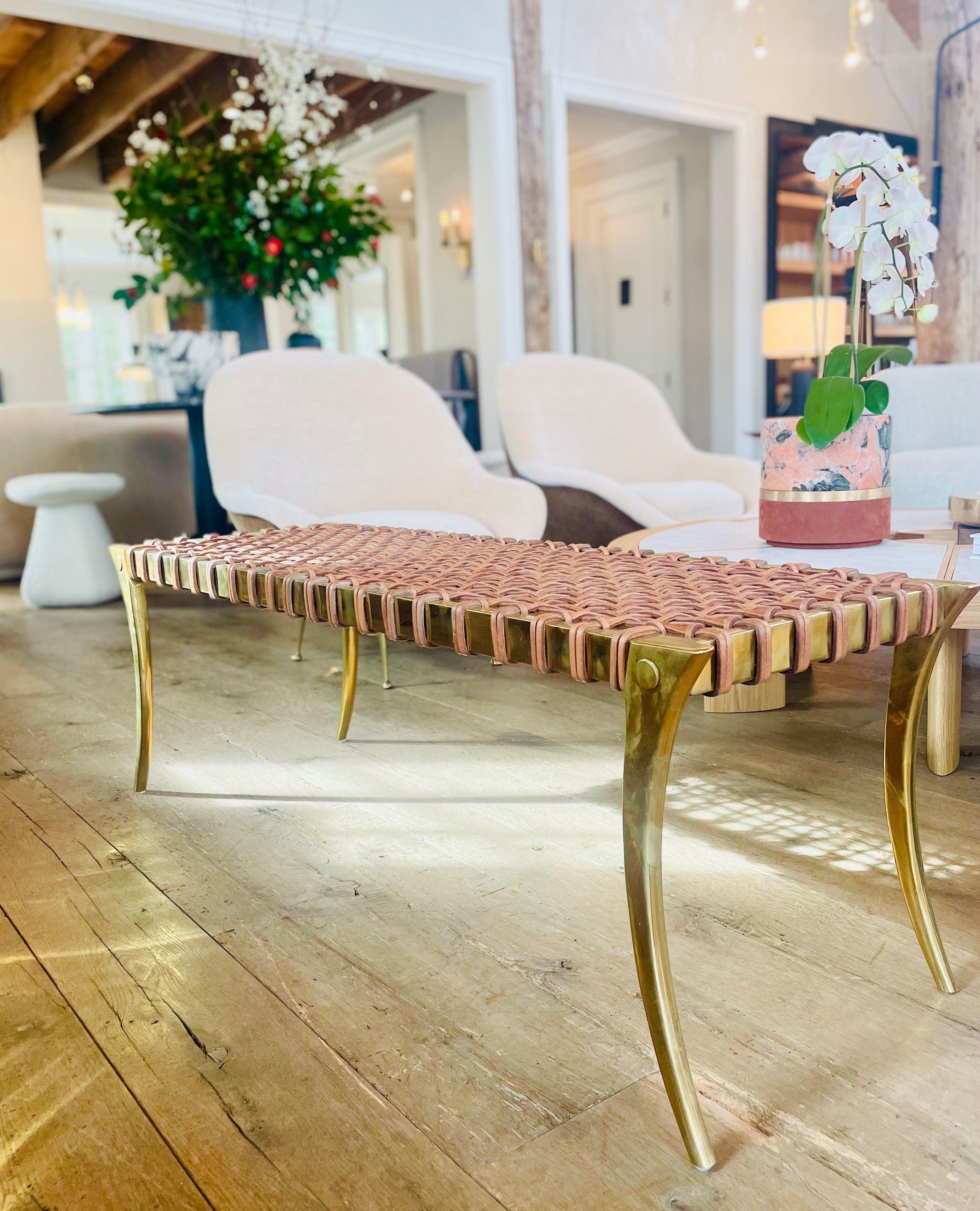 The Klismos Brass Bench is a sophisticated and stylish addition to any home. Crafted from solid cast-brass, the bench has a sleek and timeless design. It features a hand-woven leather strapped seat, adding an elegant finishing touch. Enjoy both