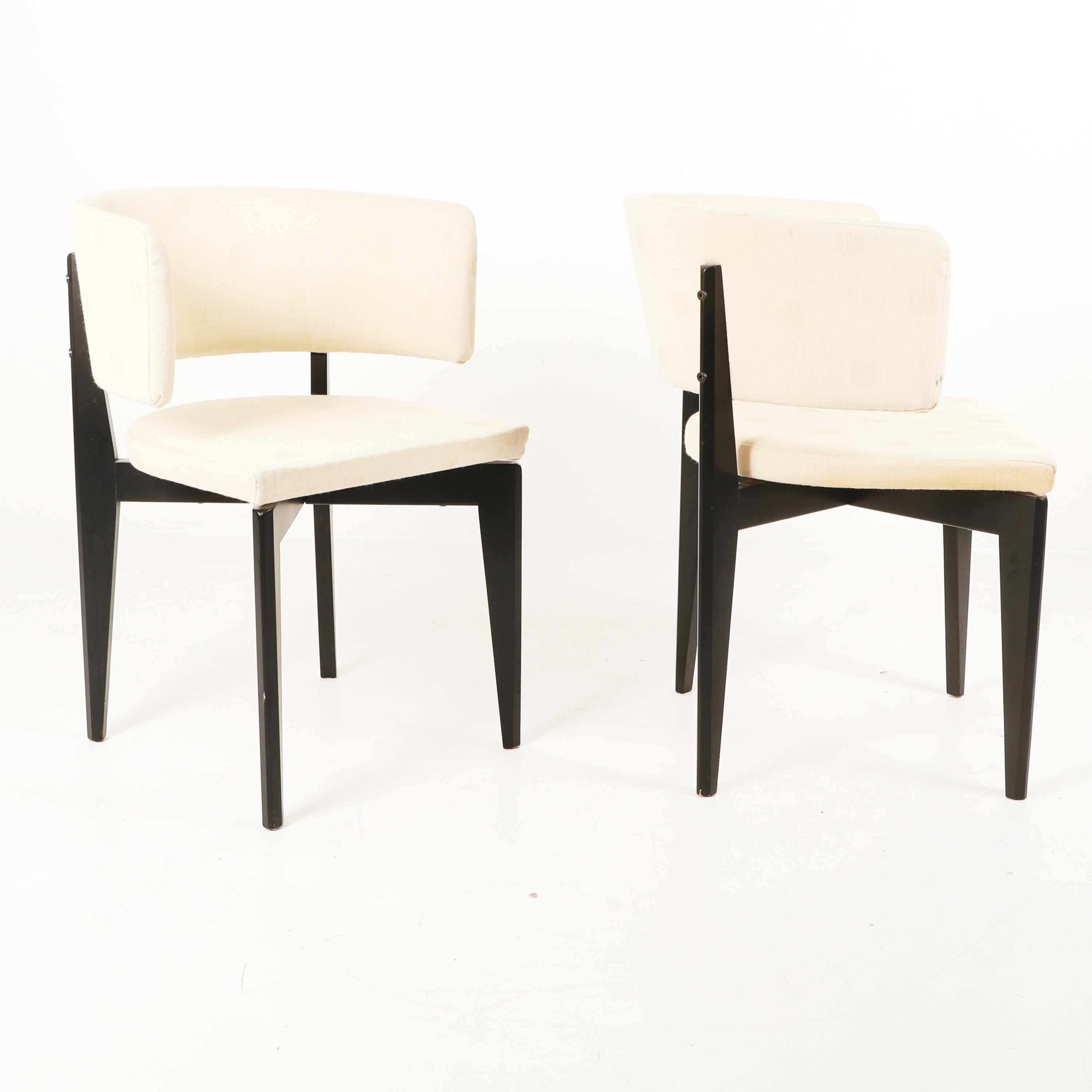 Pair of dining or side chairs with black lacquered frame, firmly upholstered back and seat, curved back, beige textile upholstery. Sculptural, Beautiful lines. 
Upholstery is original. We can reupholster for you for a small additional charge.