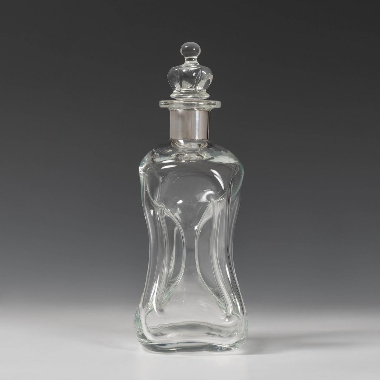 A fine 1960s Danish hand blown glass decanter with pinched sections so columns are formed at the corners and through the centre. Silver collar marked sterling and stamped with the silversmith E. Dragsted Denmark. Called a Kluk Kluk due to the sound