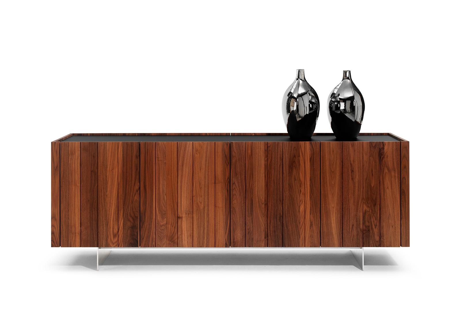 This beautiful sideboard in solid oiled walnut is an enrichment for any interior and a future heirloom. The version shown is 240cm wide, 80cm high, 50cm deep and has 4 doors. Due to the beautiful vertical accents, the transitions of the doors do not