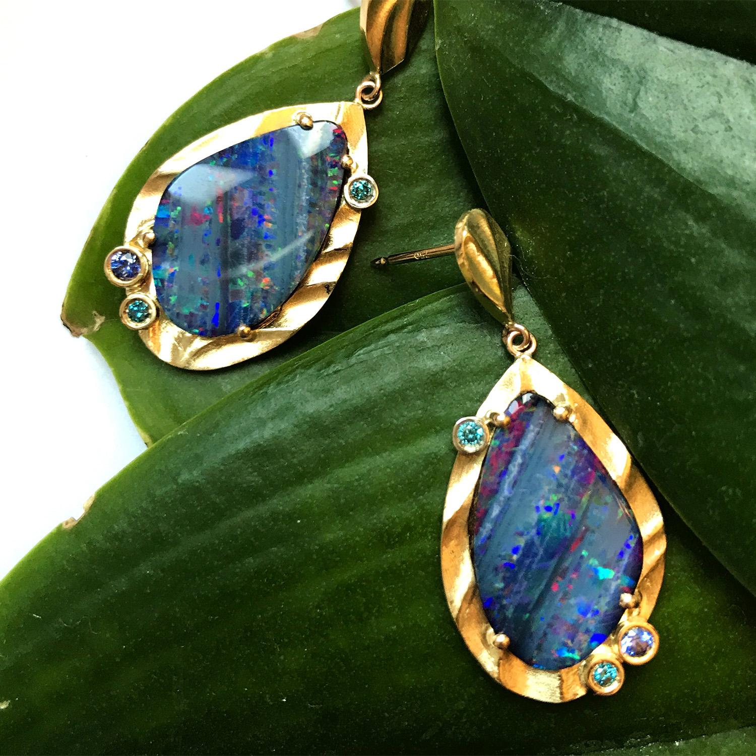 The contemporary Aurora Earrings from K.Mita are handmade by the jewelry artist from 18 Karat Yellow Gold and 11.03 Carat Opal doublets (total weight). They are accented with 0.13 Carat Blue Sapphires and 0.12 Carat Blue Diamonds. These modern drop