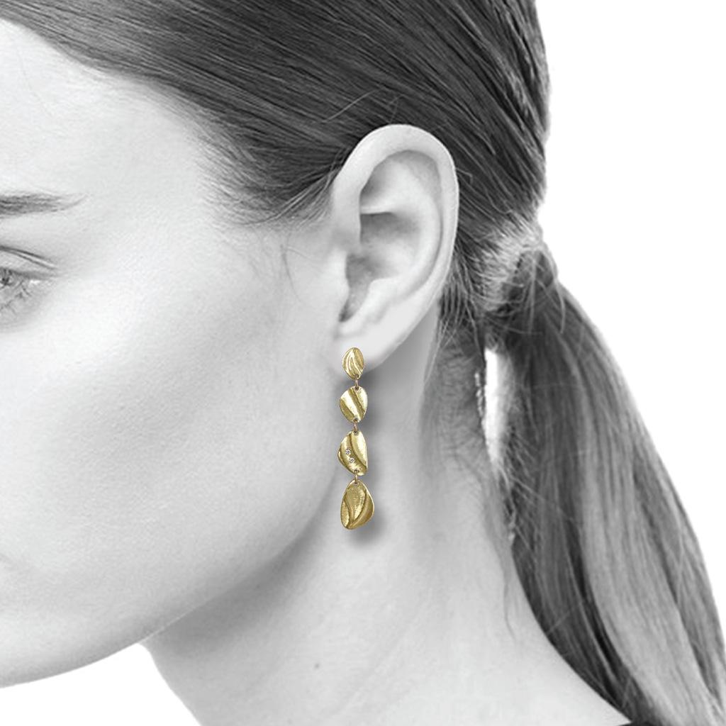 K.Mita's Pebble Dangle Earrings are handmade by the jewelry artist from 14 Karat Yellow Gold and 0.05 Carat Diamond accents, These contemporary earrings feature the artist's signature Sand Dune texture and can be worn with casual wear or at a party. 