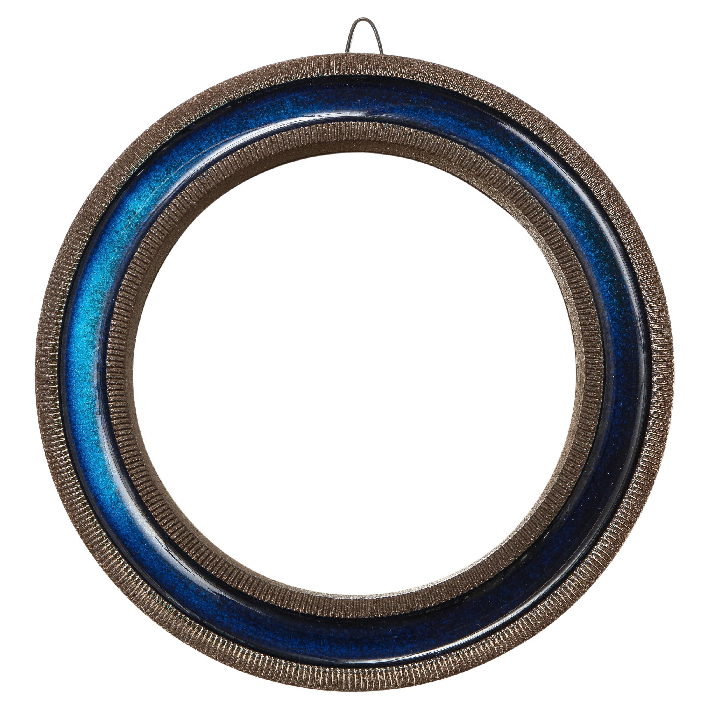 Erik Reiff for Knabstrup mirror, ceramic, blue, signed. Small scale ceramic mirror with alternating rings of texture and color - smooth dark blue glaze and ribbed brown glaze. The back is covered with a natural woven burlap and stamped Knabstrup on