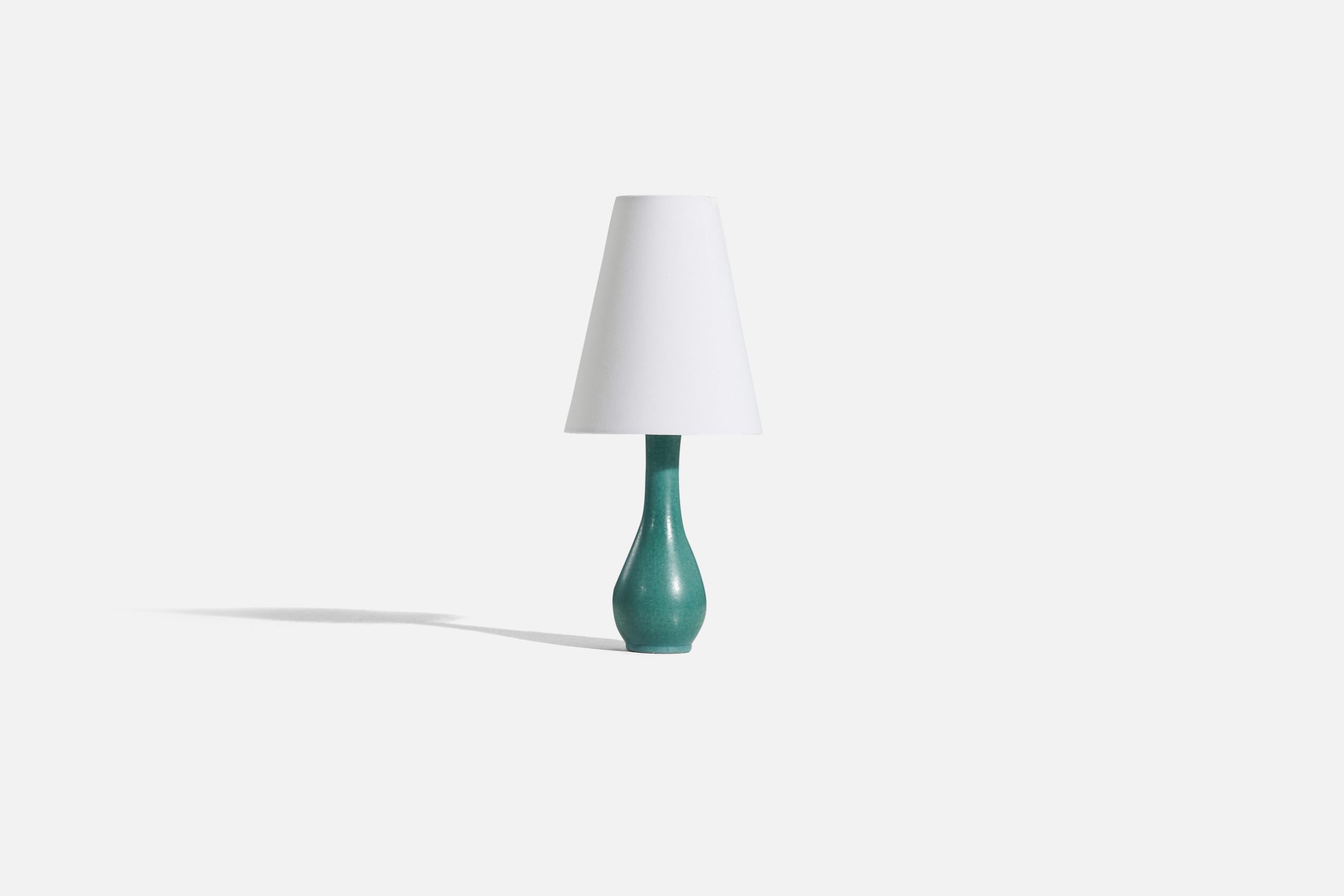 A green, glazed stoneware table lamp designed and produced by Knabstrup Keramik, Denmark, c. 1960s. 

Sold without lampshade. 
Dimensions of Lamp (inches) : 8.8125 x 2.75 x 2.75 (H x W x D)
Dimensions of Shade (inches) : 2.75 x 5.5 x 6.75 (T x B
