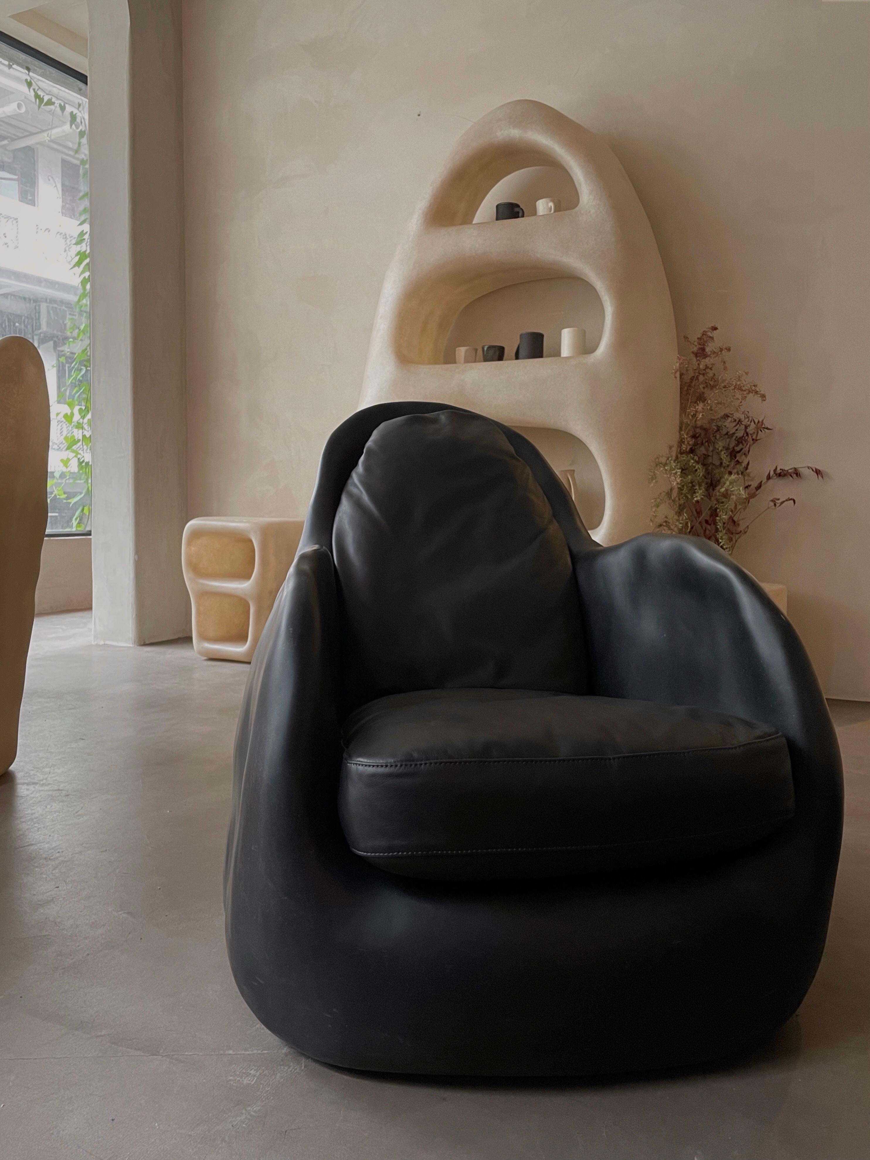 Knead Black Lounge by Karstudio.
Dimensions: W 75 x D 100 x H 78 cm.
Materials: FRP.
Available in white.

Kar, is the root of Sanskrit Karma, meaning karmic repetition. We seek the cause and effect in aesthetics, inspired from the past, the