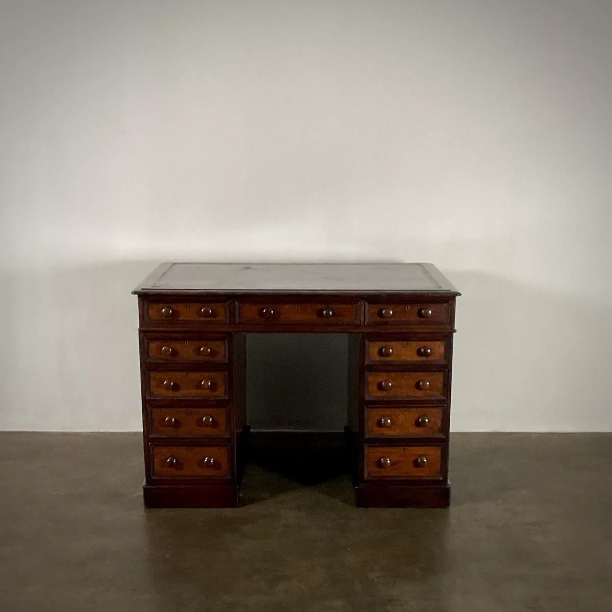 Petit bureau anglais à genouillère du 19e siècle avec une patine exquise et de charmantes poignées à bouton sculpté. Ce bureau présente une riche teinte châtaigne, parfaite pour un bureau ou une étude privée, démontrant à quel point son bois a