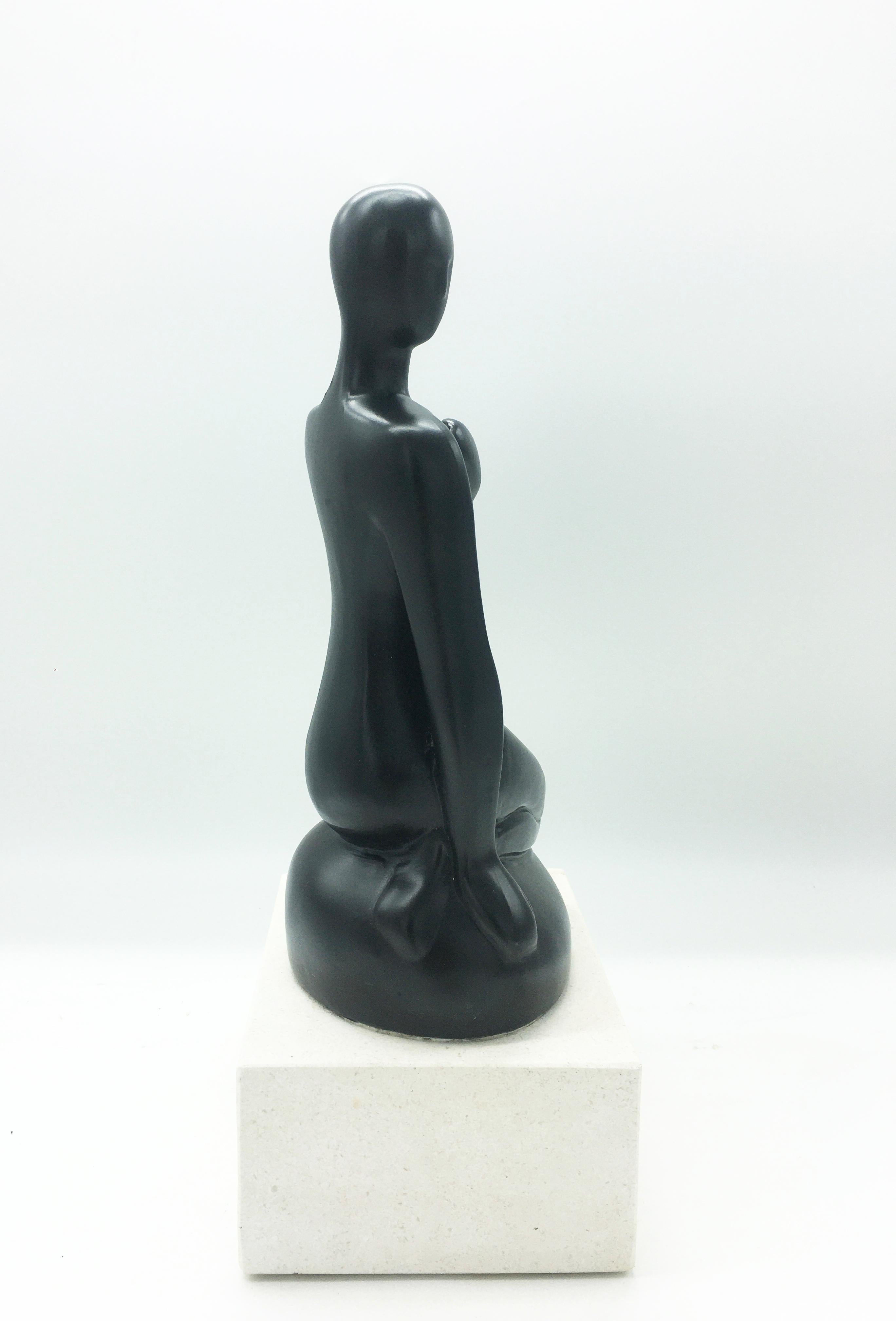 Delightful resin sculpture on a white marble base,