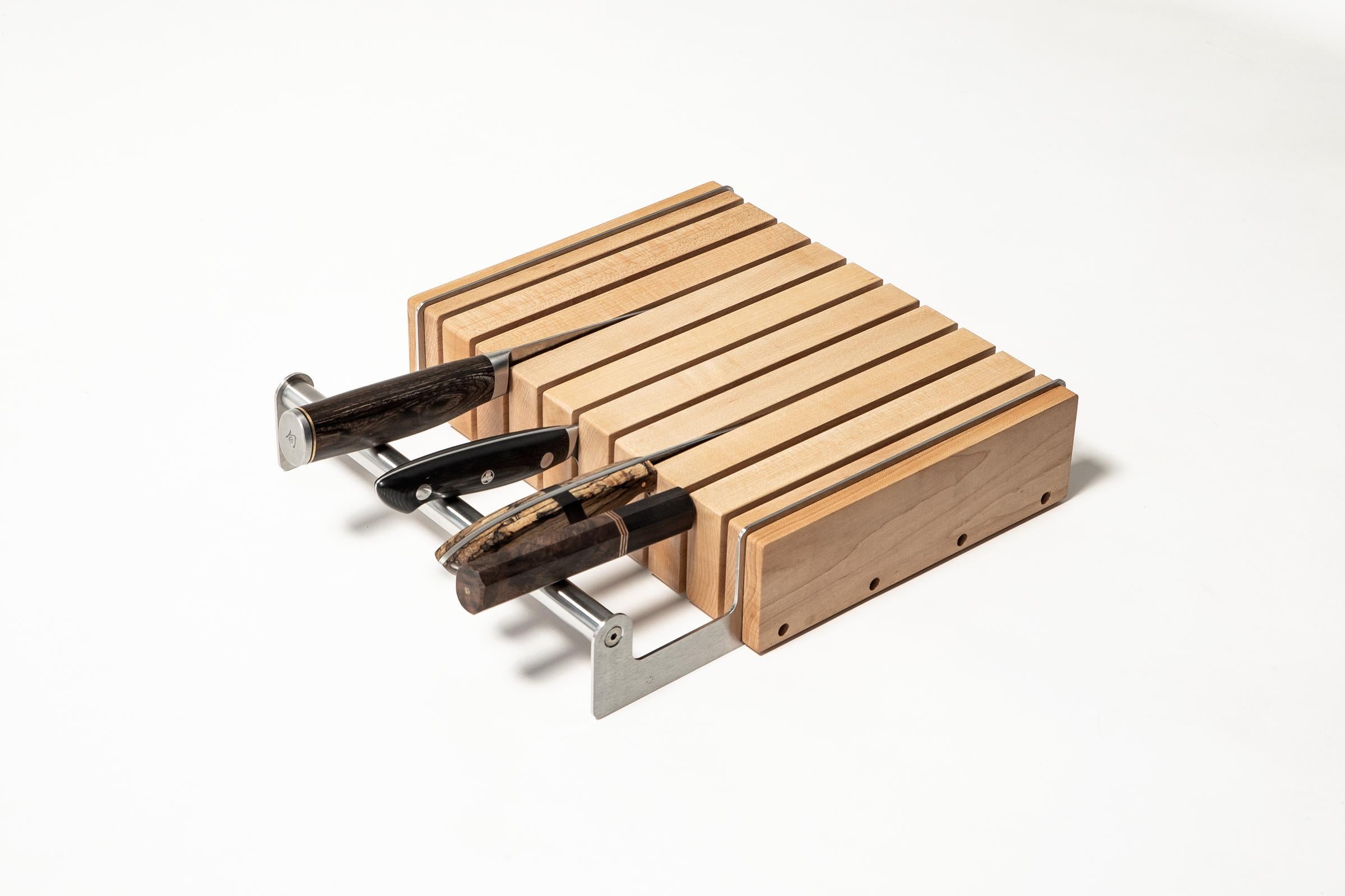 A Knife Block equal to your finest blades. Put it in the drawer or better yet, leave it on the counter.

Shown in solid maple with mineral oil finish & stainless steel.  Holds 12 knives up to 10