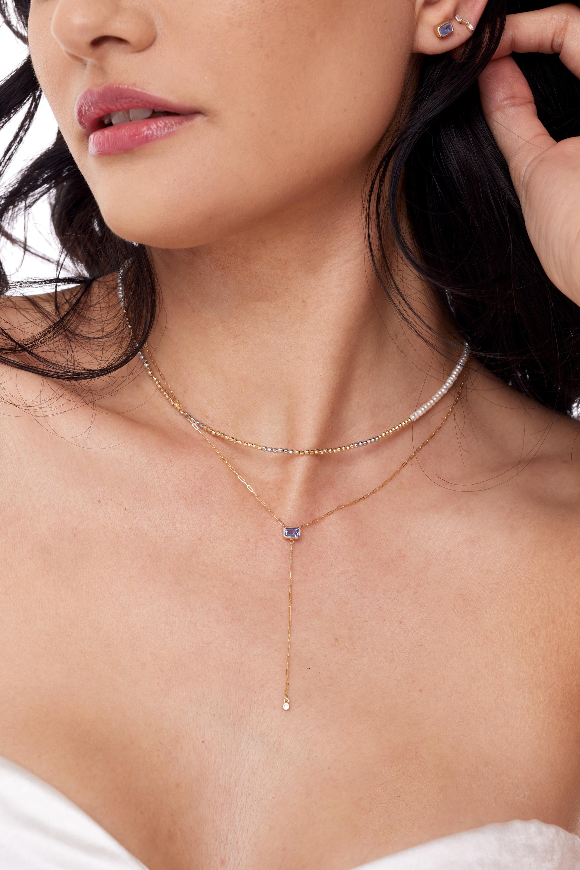 We have taken our MINI paper clip chain and added a DROP and something shiny to it! Say hello to our KNIFE EDGE Y-Neck Gemstone Necklace-This version shows off a beautiful  Emerald cut Tanzanite gemstone! with a Diamond bezel. Turn heads with the