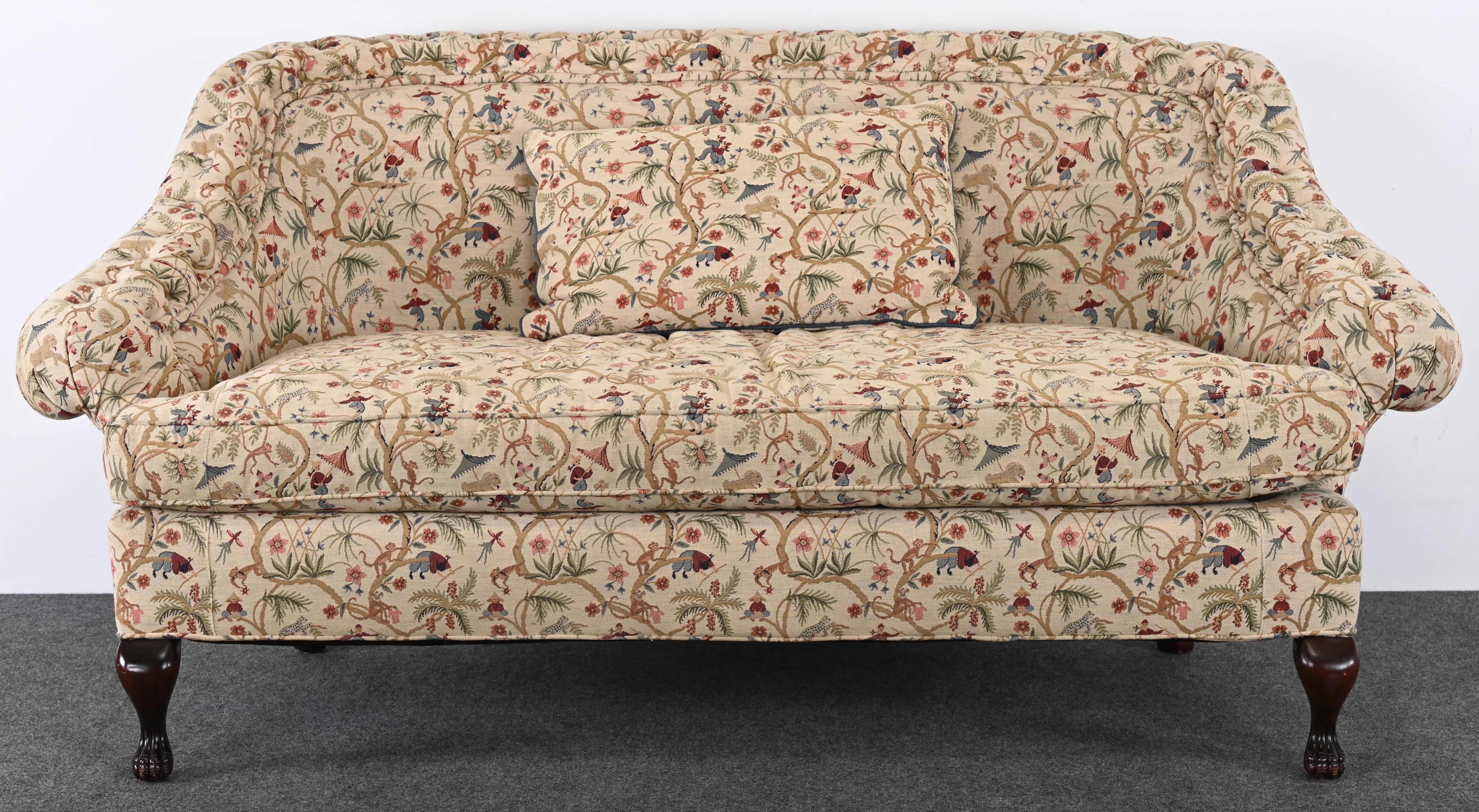 A decorative English sofa specially made for Harrod's Fine Furniture Collection. The Victorian-style settee or loveseat is upholstered in an authentic period fabric. This sofa would look great in any Victorian home with a traditional aesthetic.