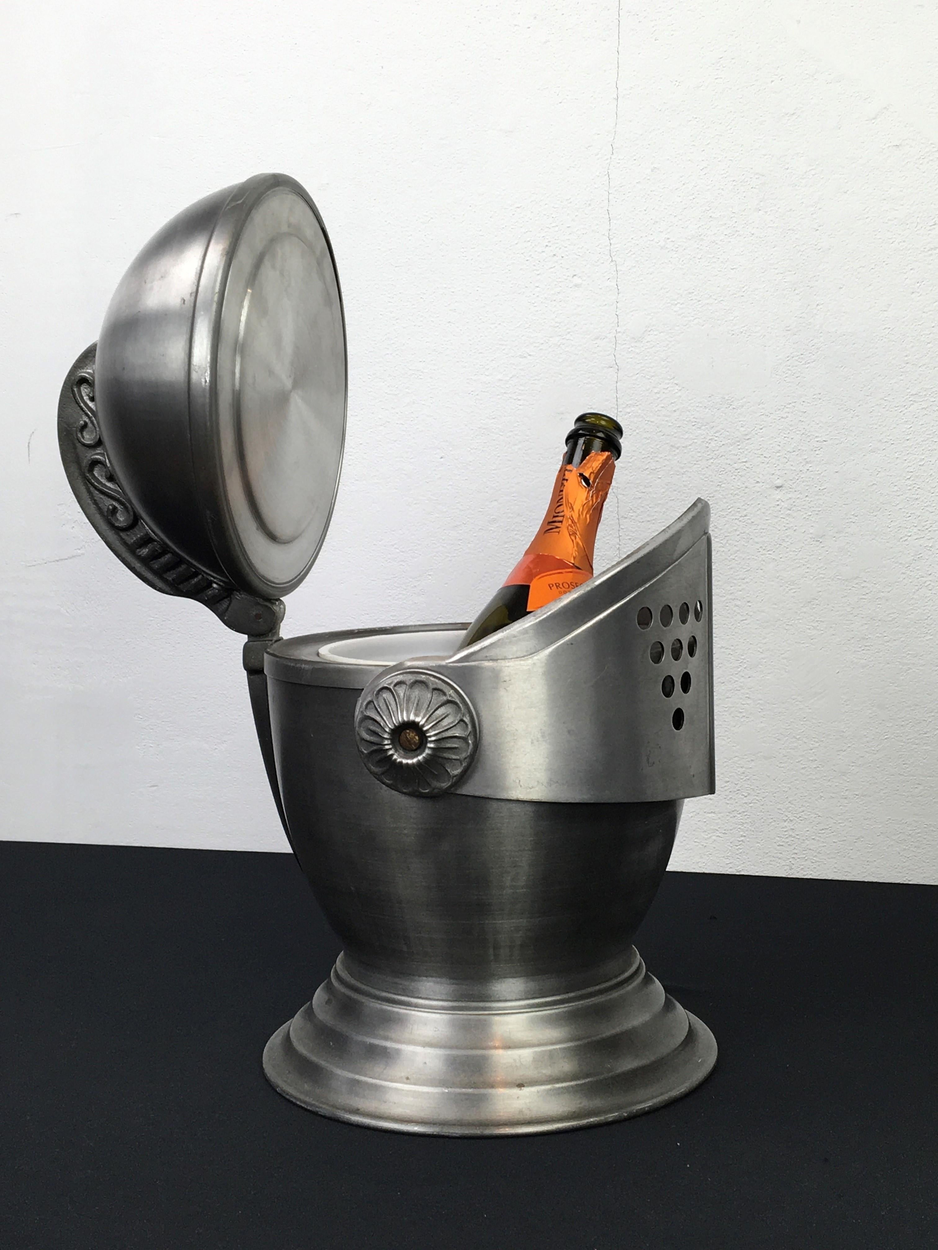 Vintage Knight's helmet ice bucket. 
An ice bucket made of brushed alumiunium in the shape of a helmet of a knight. 
A great looking ice bucket from the 1970s which was made in Hong Kong. 
Can be used as a wine cooler, ice bucket or is great as