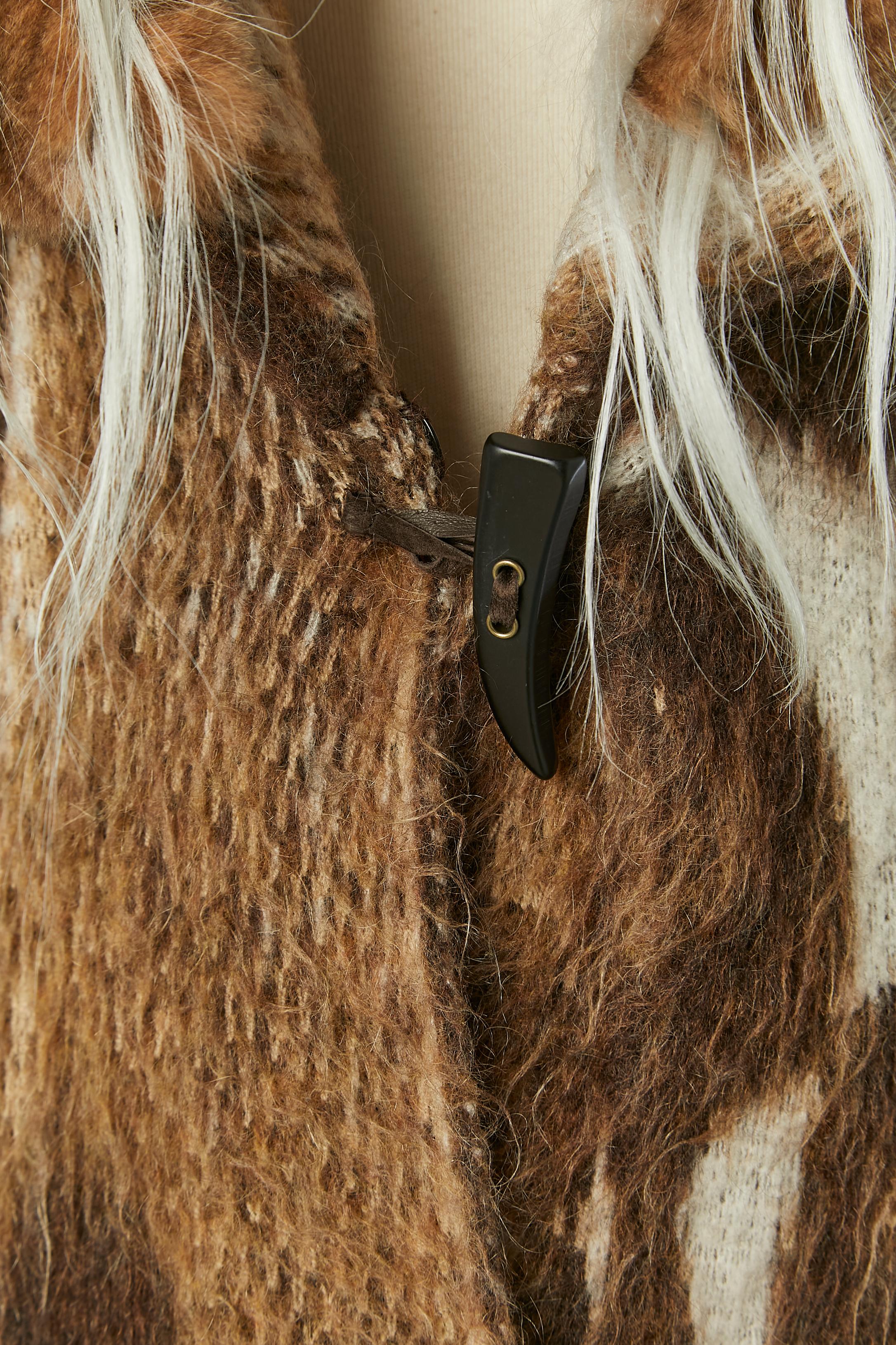 Knit jacquard coat with animal pattern and fur patchwork collar. Knit composition: 38% mohair, 38% wool, 19% polyamide, 5% elasthane.
Fur: Orylag ( rabbit ) The collar is detachable with button and buttonhole. One button and buttonhole closure on