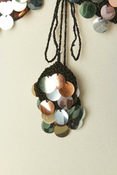 Knit lurex short vest with large pastel sequin and laces closure  Circa 1970's