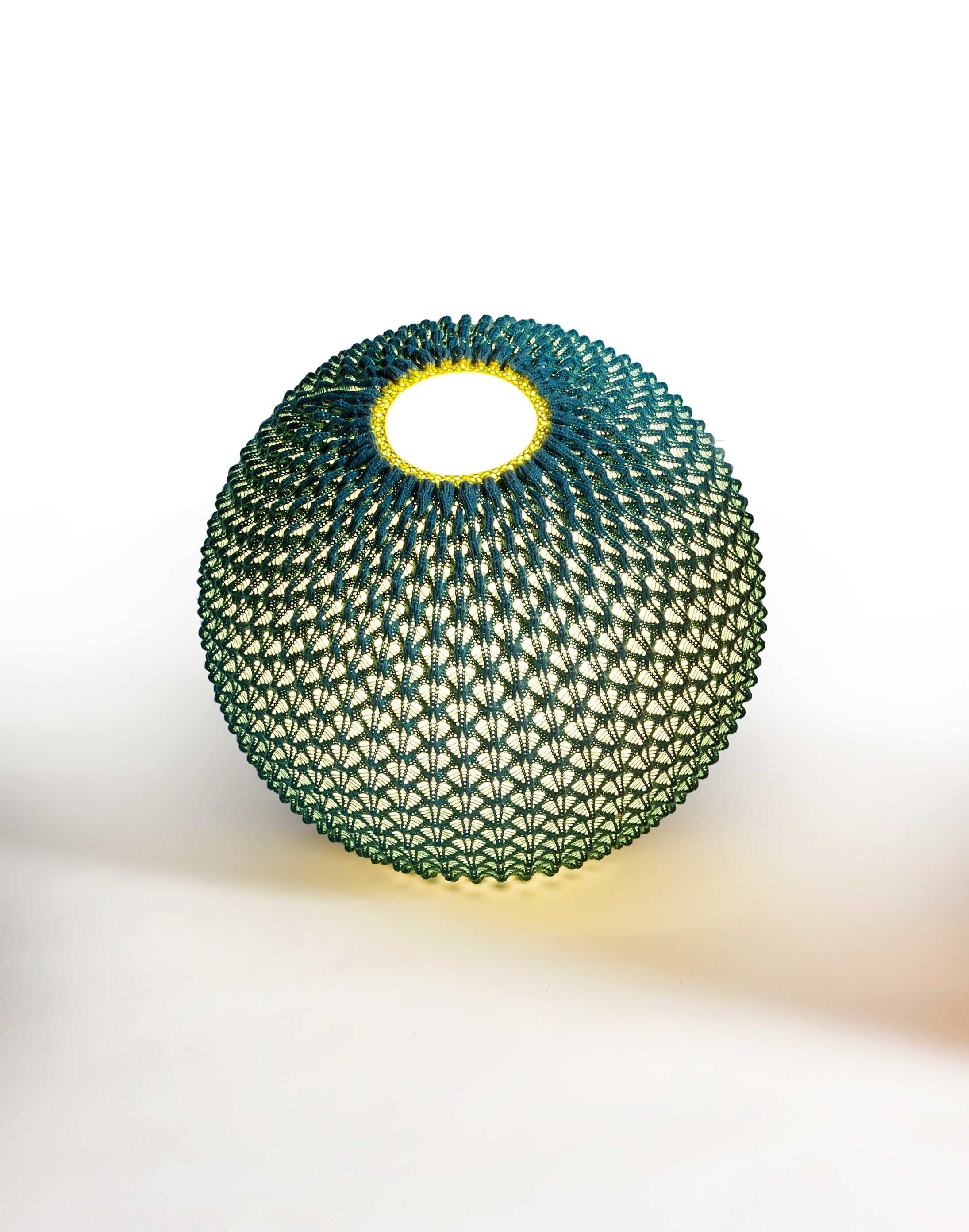The Knitted lighting is an award-winning collection 

series of lightings that combines technology with tradition 
Knitting acrylic threads in fixed patterns with wool crochet, creates a three-dimensional sheet of fabric 
which serves as a lighting