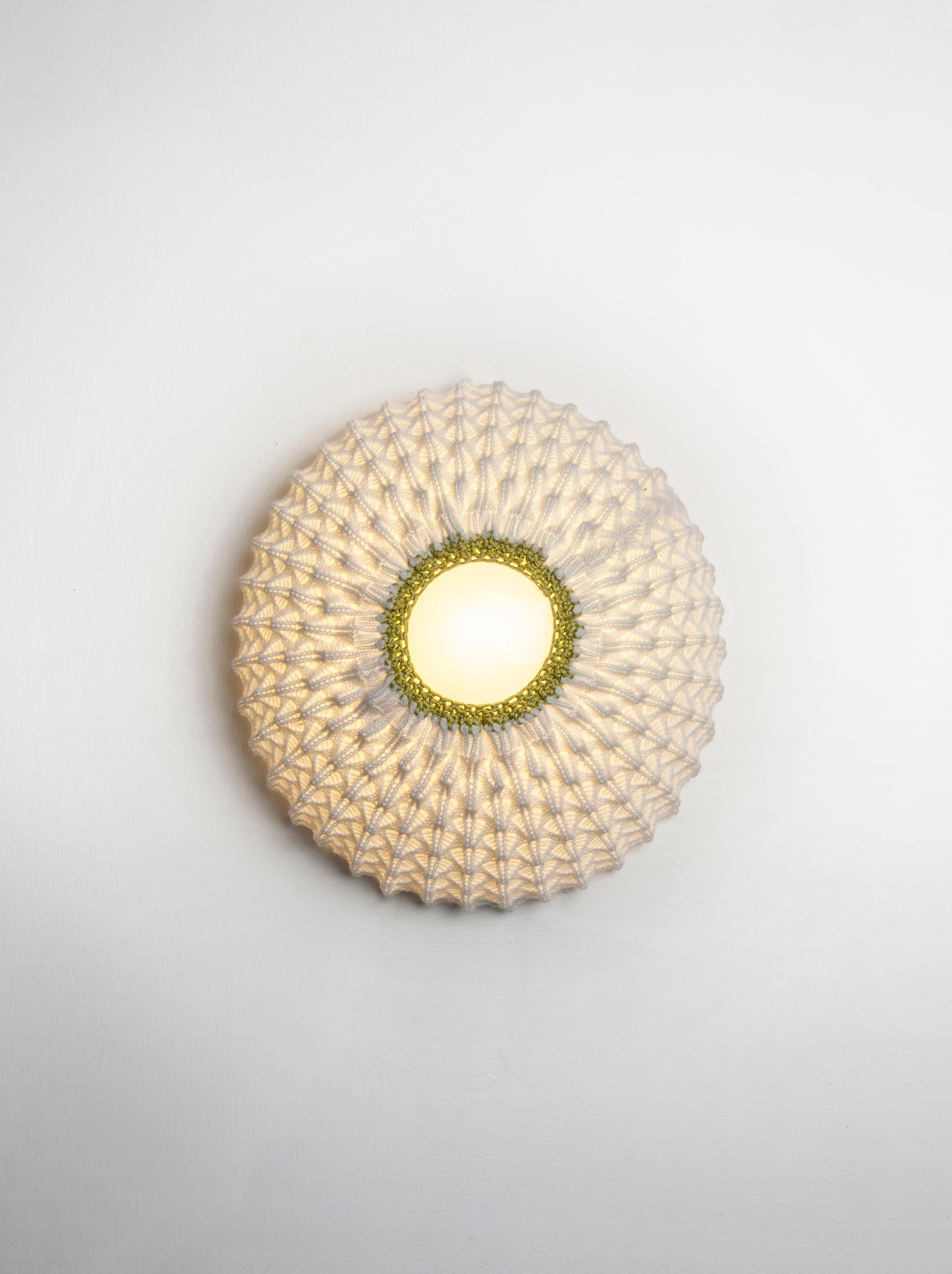 series of lightings that combines technology with tradition 
Knitting acrylic threads in fixed patterns with wool crochet, creates a three-dimensional sheet of fabric 
which serves as a lighting fixture.
Fitting the fabric onto a rigid skeletal