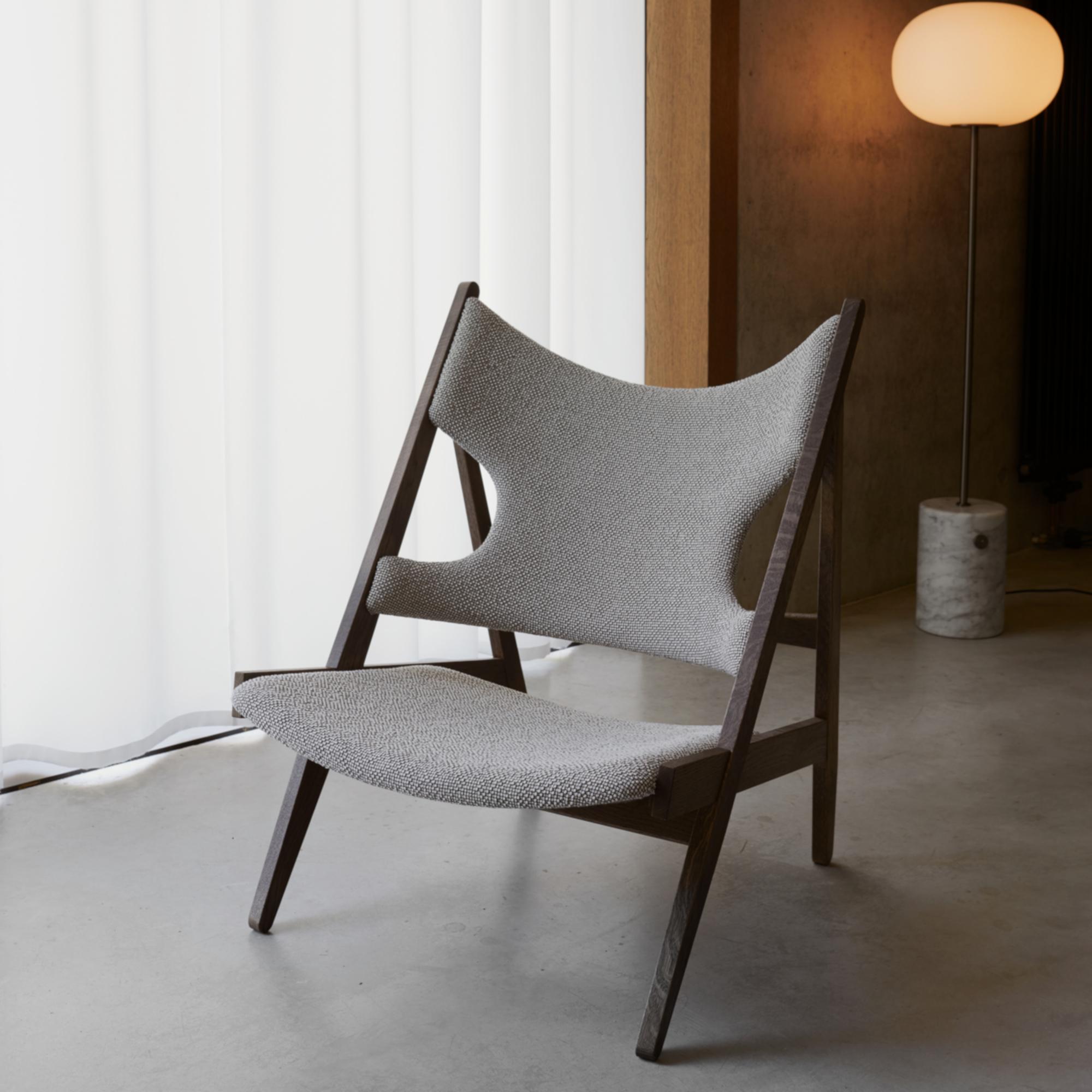 Defined by an exposed, triangular construction, a gently curved seat and back ideally pitched for relaxation, and distinctive cut-outs for resting the elbows when reading (or, of course, knitting), the knitting chair affirmed Kofod-Larsen’s
