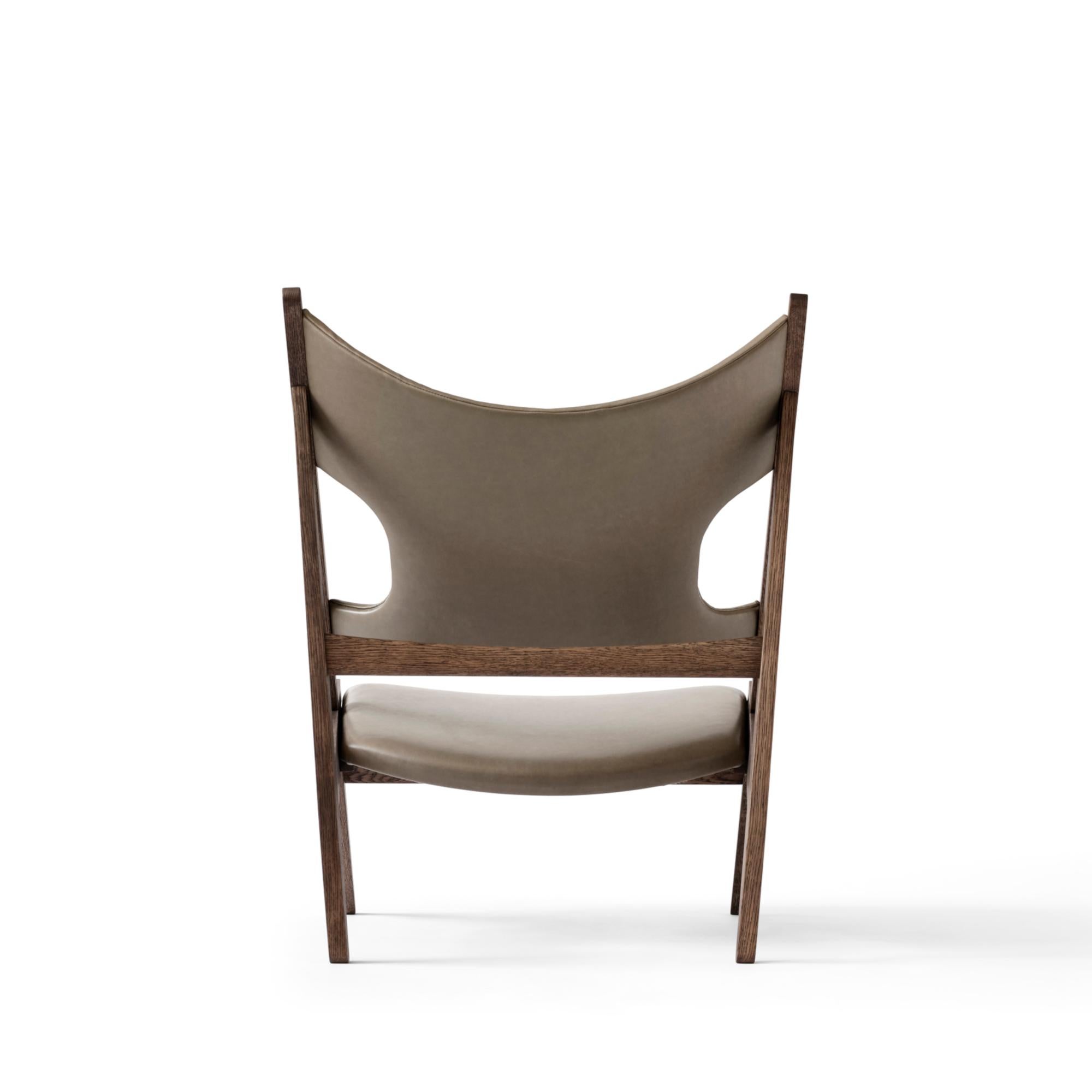 Defined by an exposed, triangular construction, a gently curved seat and back ideally pitched for relaxation, and distinctive cut-outs for resting the elbows when reading (or, of course, knitting), the Knitting Chair affirmed Kofod-Larsen’s