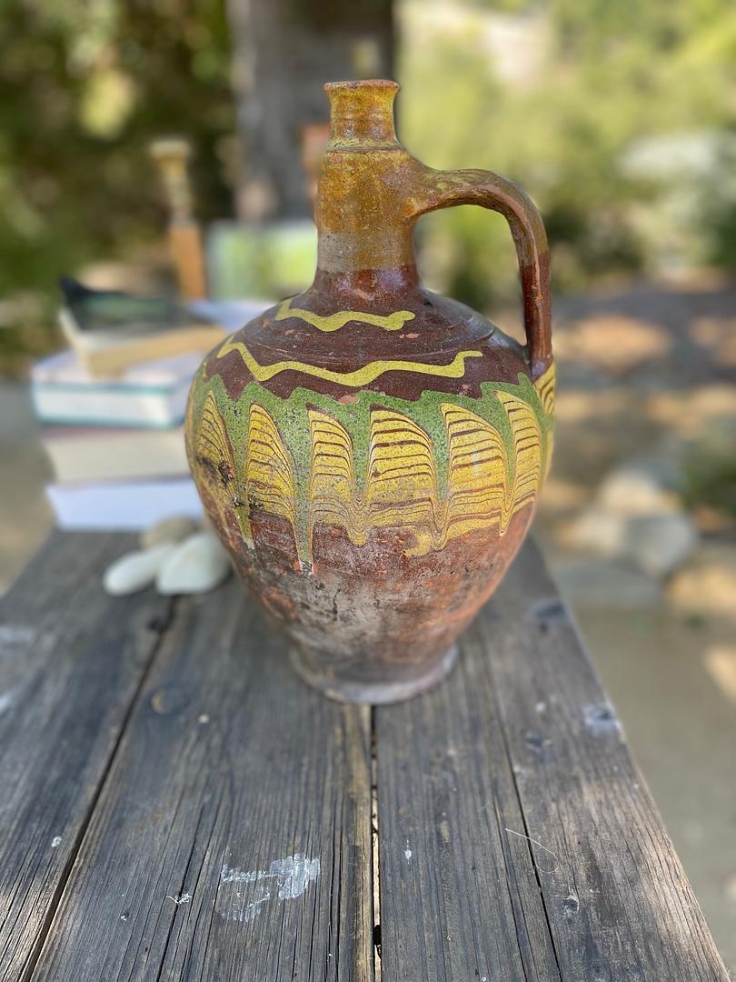 Kınık is a traditional Anatolian pottery technique that blends control and chance to create one-of-a-kind designs on the surface of each piece. This medium-sized Kınık Küpü was likely used to store or preserve goods, like pekmez, a thick