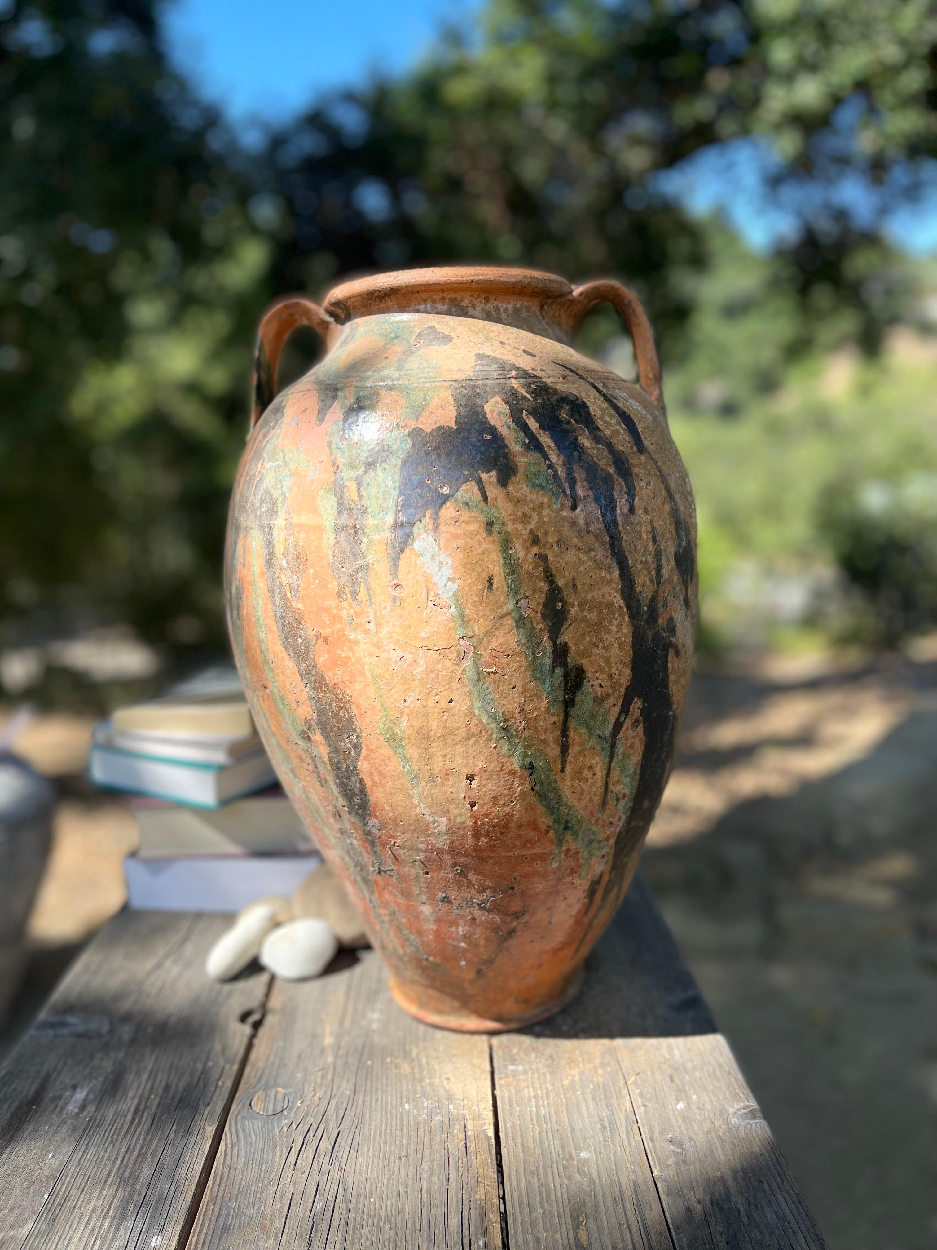 Kınık is a traditional Anatolian pottery technique that blends control and chance to create one-of-a-kind designs on the surface of each piece. This large Kınık Küpü was likely used to store or preserve goods, like olive oil. 

Using an ox horn