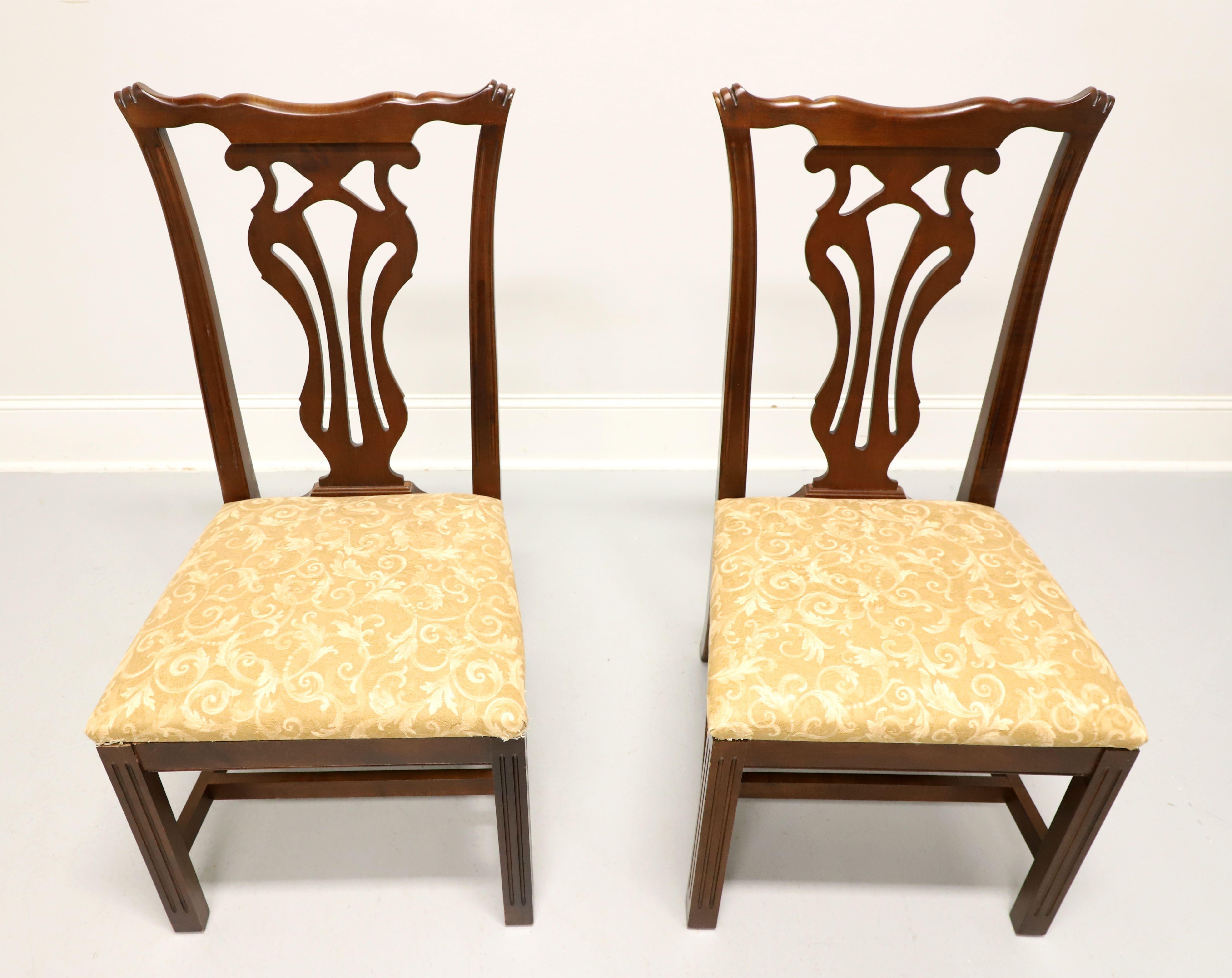 A pair of dining side chairs in the Chippendale style by Knob Creek. Mahogany with carved backrests, gold brocade fabric upholstered seat, stretcher base, and straight legs. Made in the USA, in the late 20th Century.

Measures:  Overall: 20w 22d