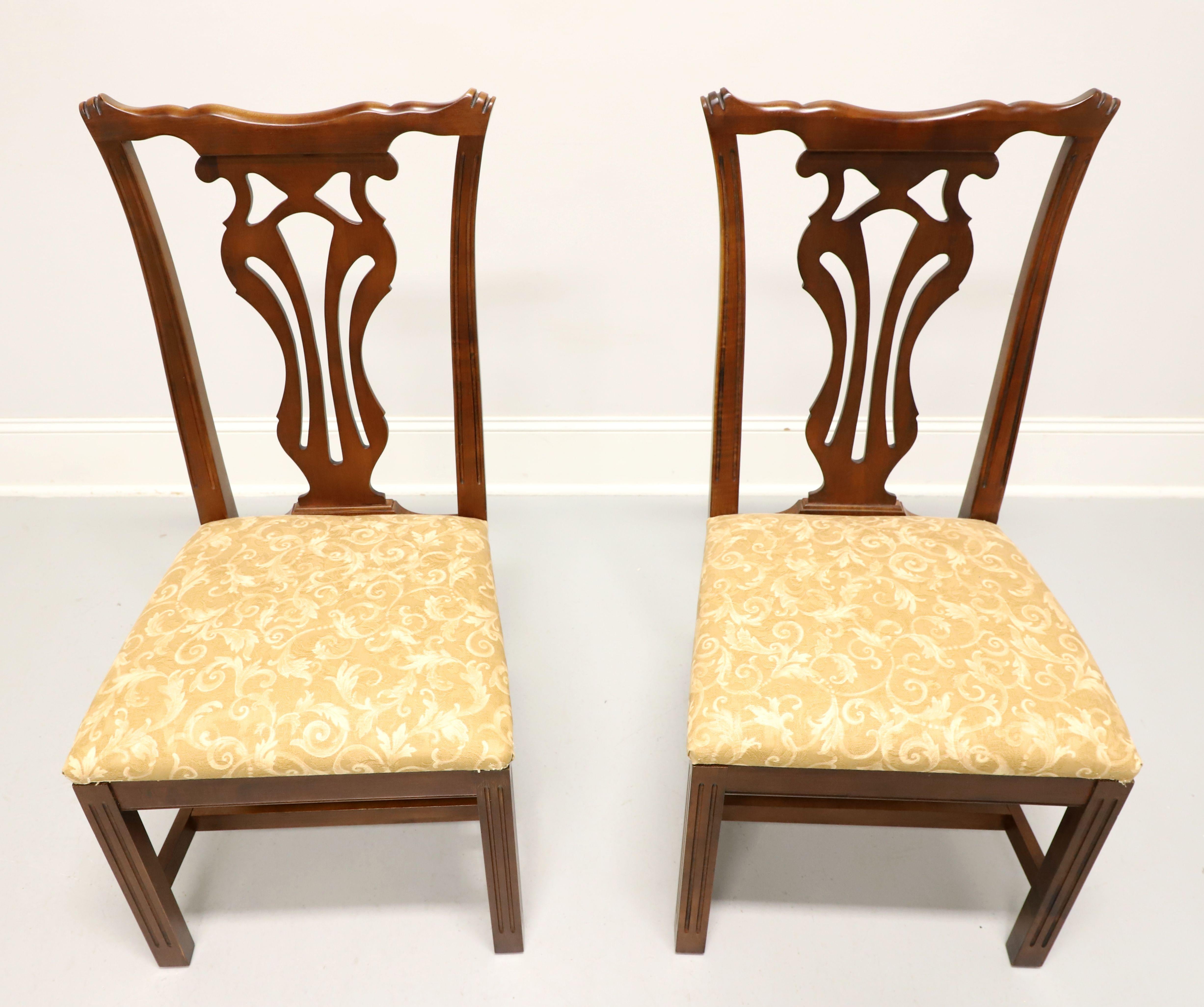 A pair of dining side chairs in the Chippendale style by Knob Creek. Mahogany with carved backrests, gold brocade fabric upholstered seat, stretcher base, and straight legs. Made in the USA, in the late 20th Century.

Measures:  Overall: 20w 22d
