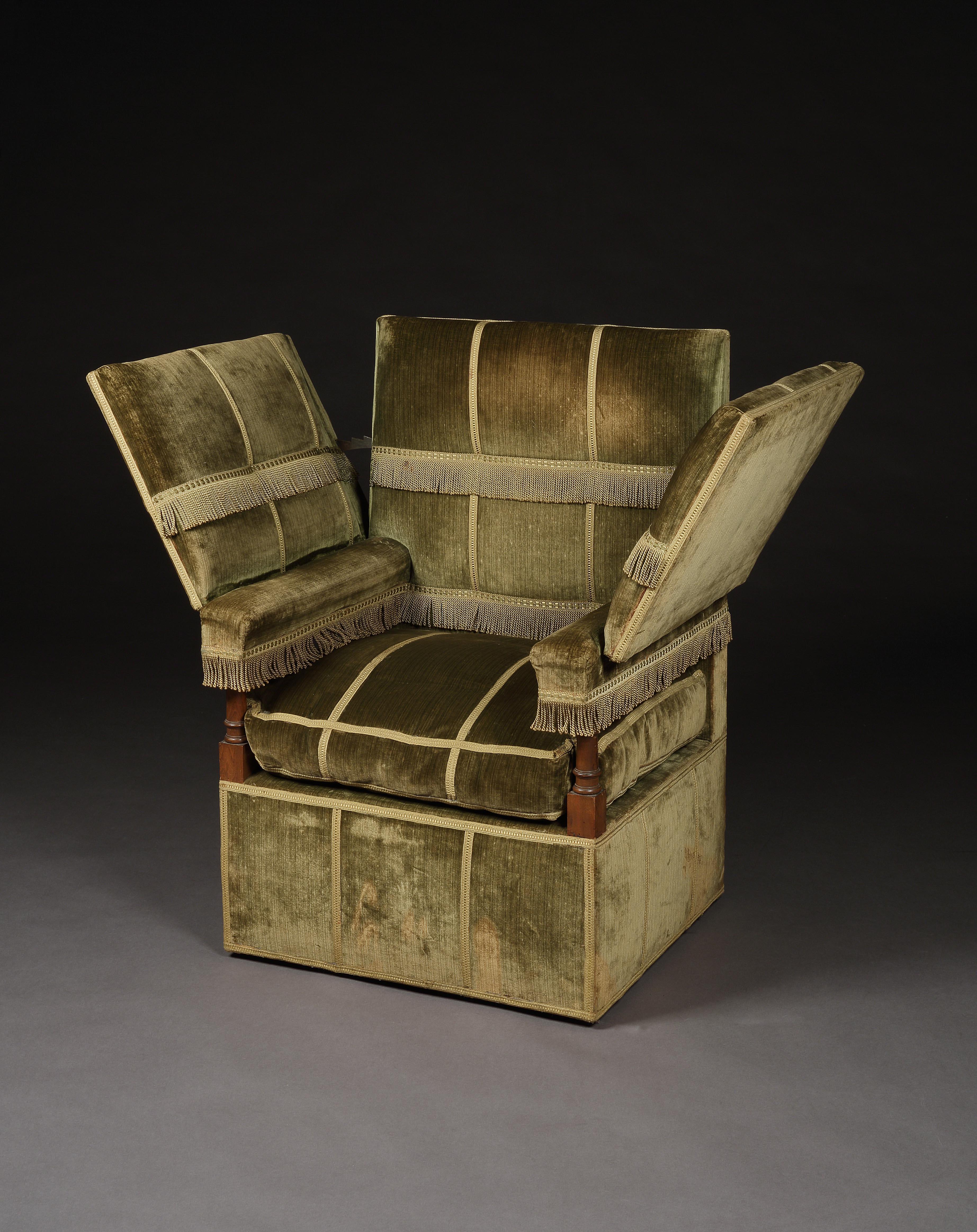 This is an early 20th century interpretation of an armchair inspired by the infamous, sumptuously, upholstered, 17th century, couch with hinged arm rests, found at Knole Park, Sevenoaks, Kent, the ancestral seat of the Sackvilles made by the most