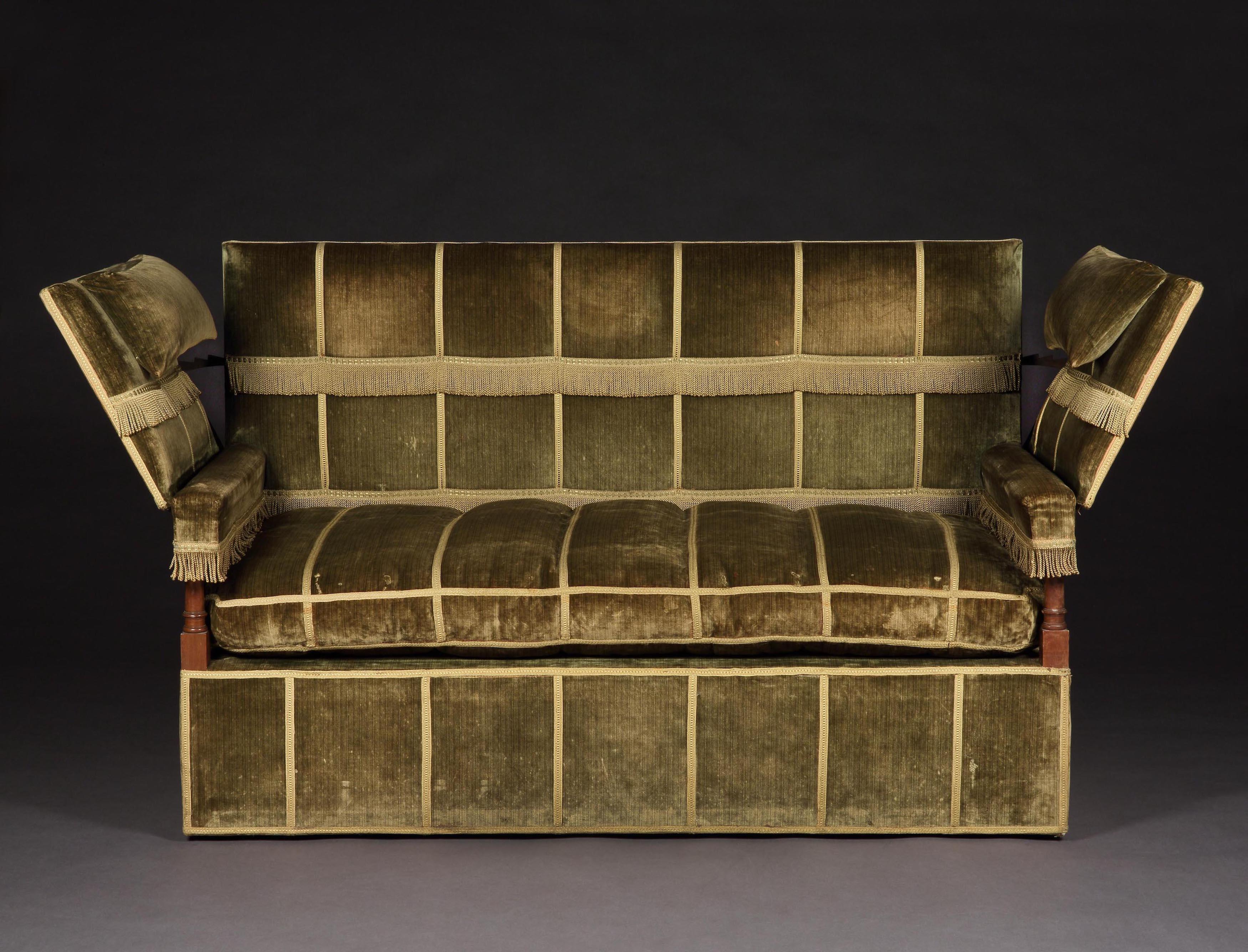 This is an early 20th century interpretation of the infamous, sumptuously, upholstered, 17th century, couch with hinged arm rests, found at Knole Park, Sevenoaks, Kent, the ancestral seat of the Sackvilles made by the most eminent upholsterer of the