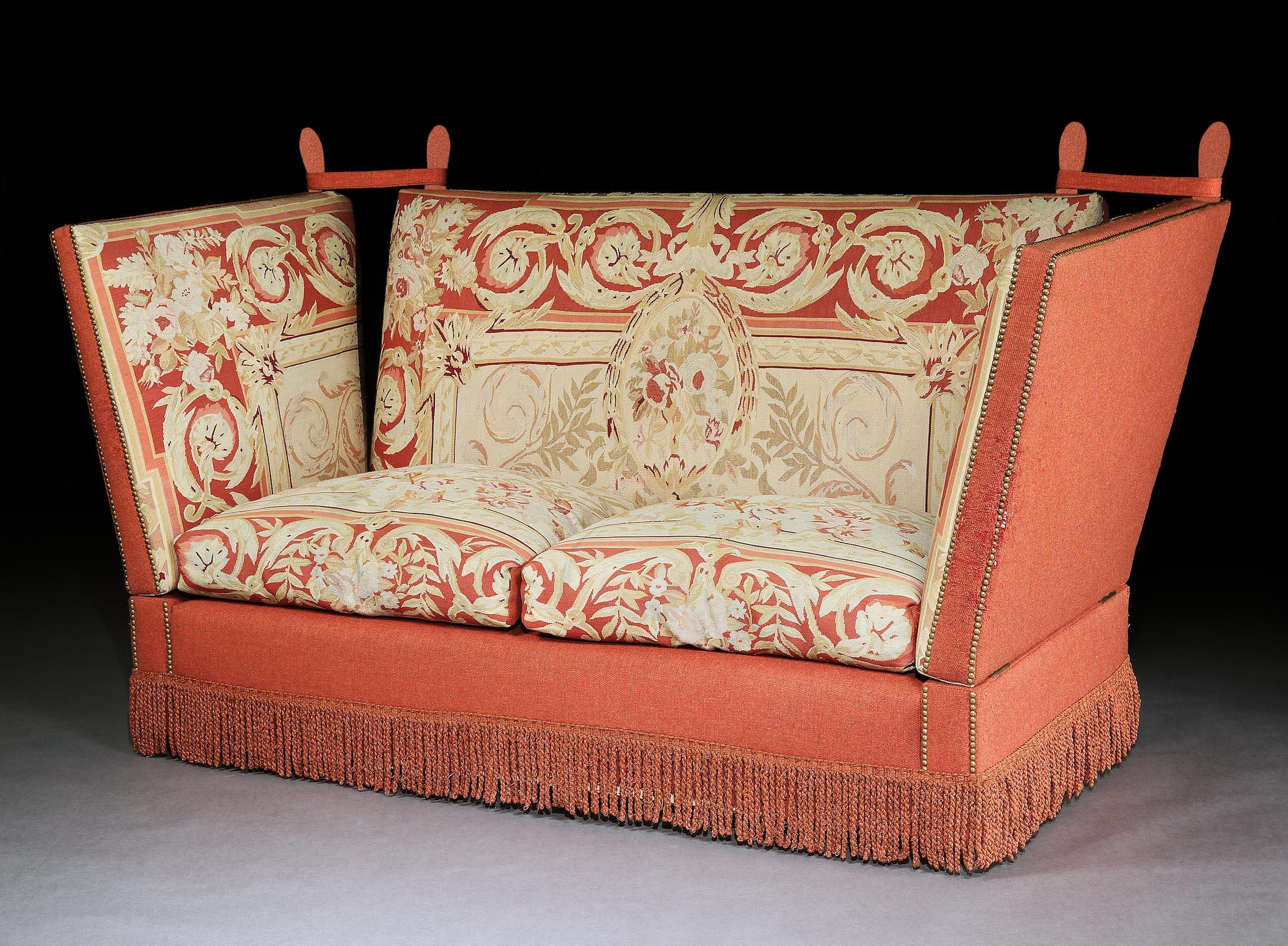 This settee exudes the Victorian country house style. It is unusual to be upholstered in Aubusson tapestry which is striking and gives it gravitas. It is very comfortable and designed for ultimate relaxation and draught-free protection.

The