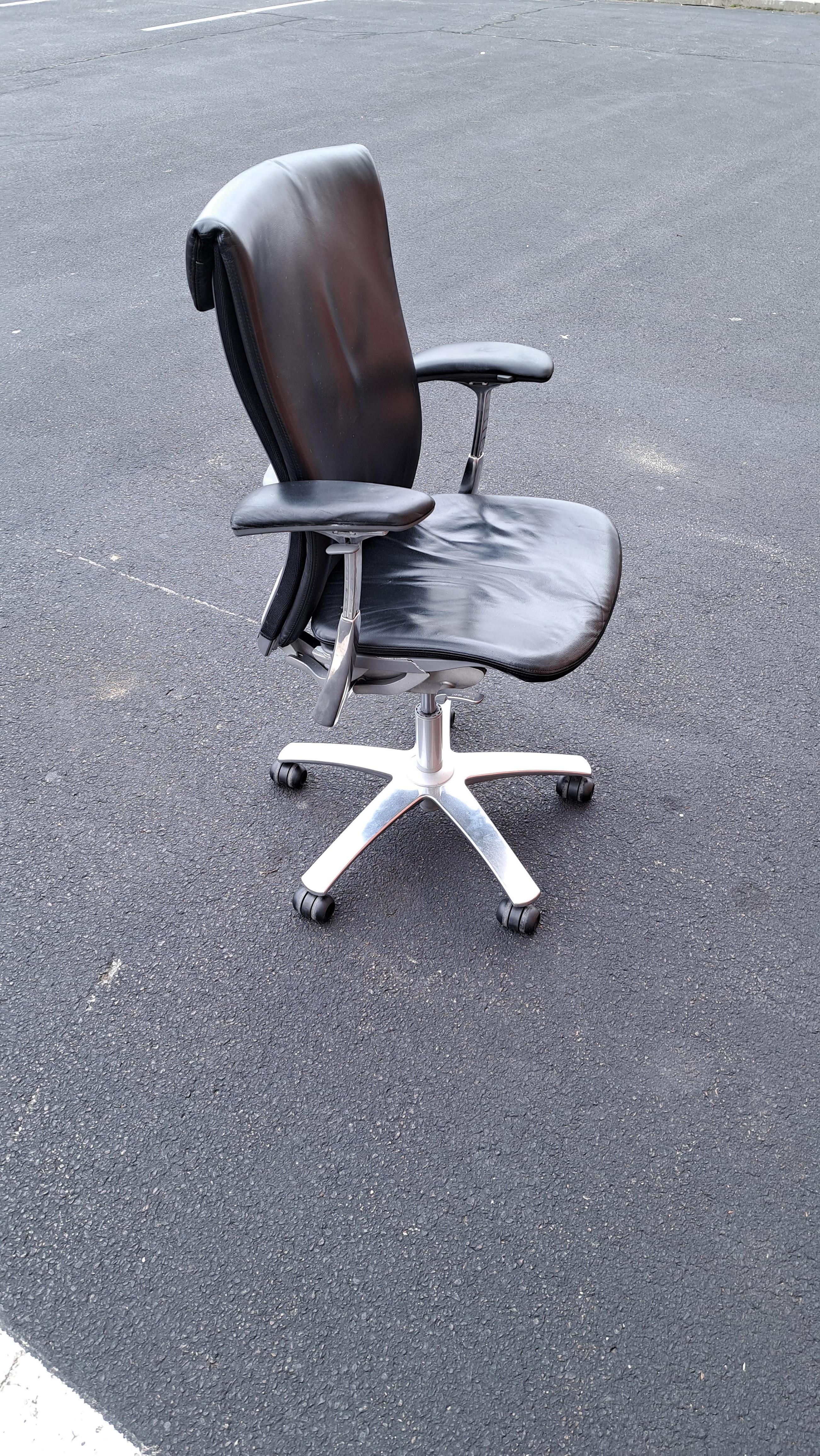 Knoll Life fully adjustable office chair. Aluminum and black leather chair with casters and Knoll stamp.