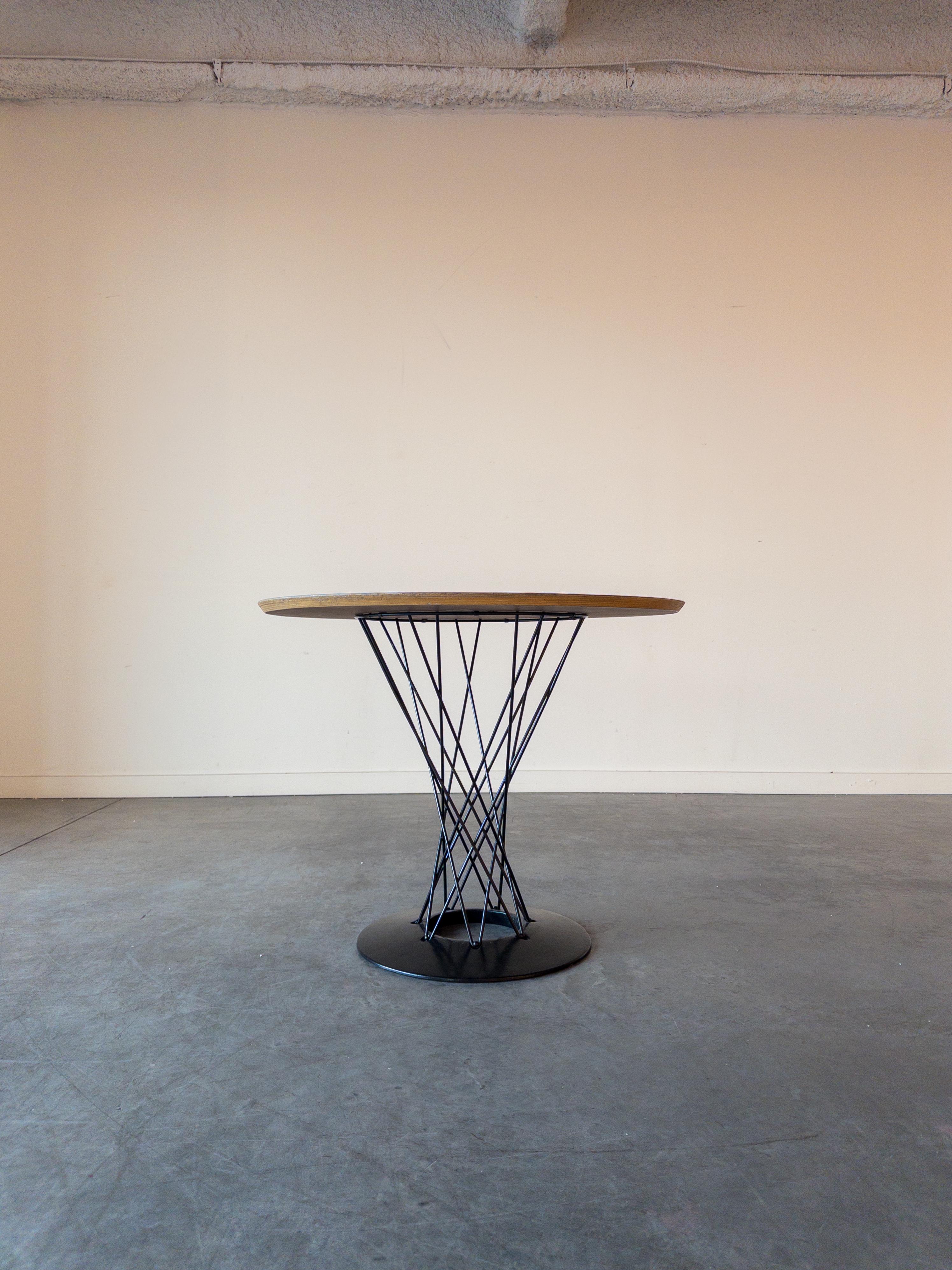 Knoll Cyclone Table designed by Isamu Noguchi for Knoll. This example dates to the 1960s. The piece has a cast-iron base which is coated in black porcelain enamel and has a white laminate top. This version features the 36