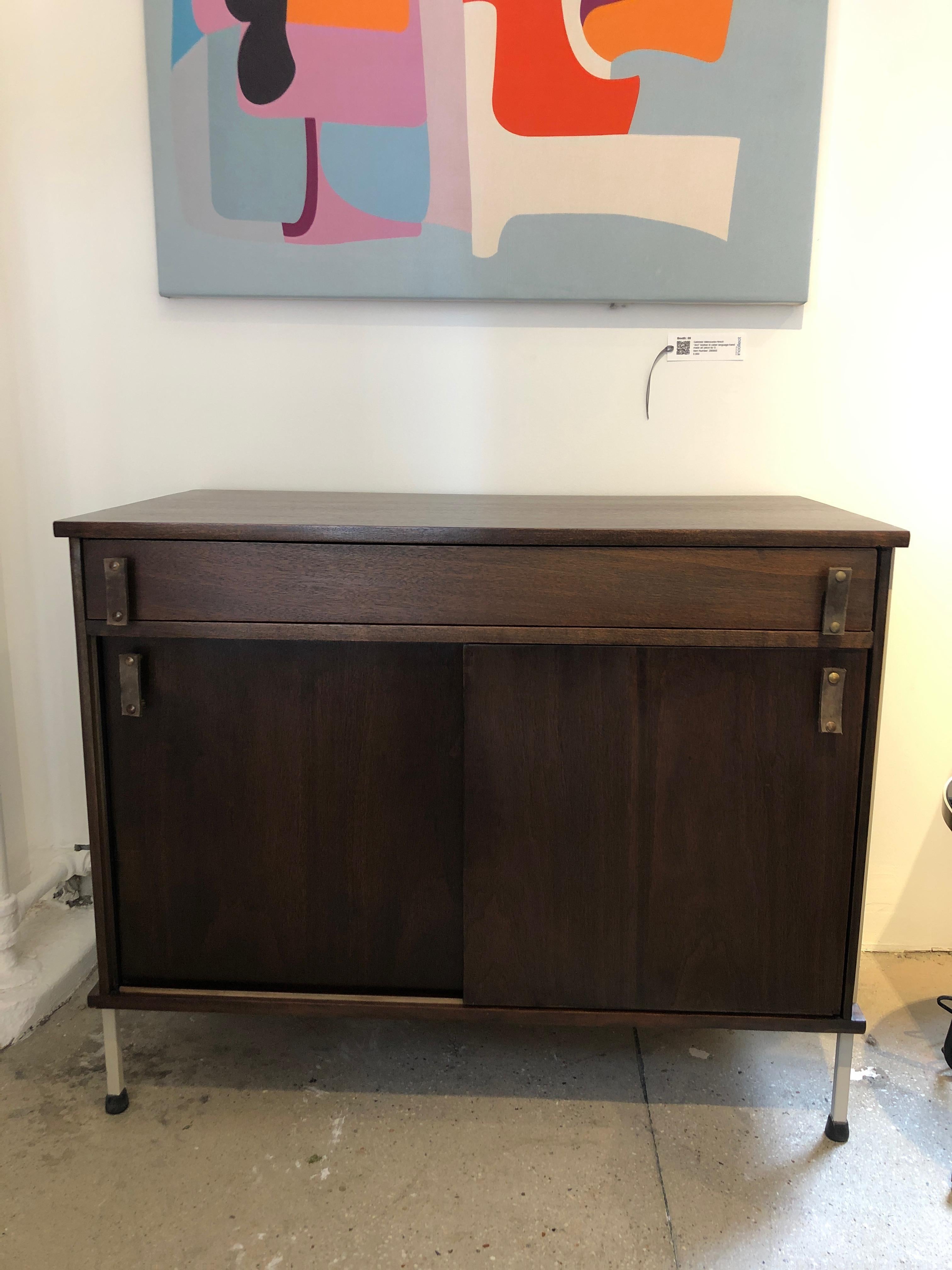 Rare Knoll and Drake walnut cabinet on white steel legs with single drawer over sliding doors. Original shelf, as well as leather handles have been replaced. The collaboration was between Knoll Associates and Drake Furniture/Austin Industries, in