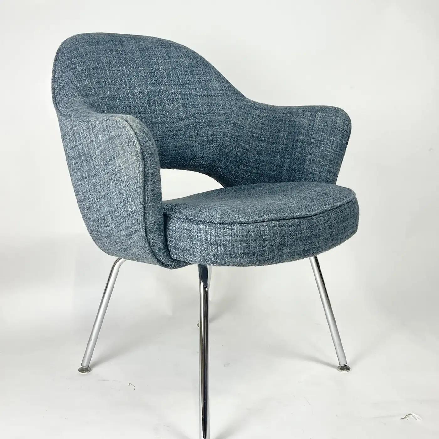 Executive armchair designed by Eero Saarinen and manufactured by Knoll. Has original label as well as Knoll ticking on underside of each chair. This chair is in very good original condition ready for use. A dark blue grey color believed to be