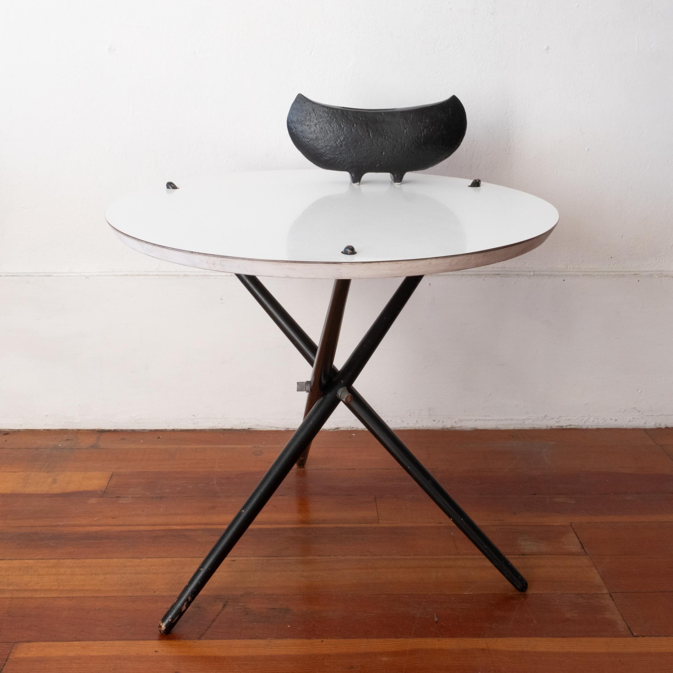 Hans Bellman tripod side table, Knoll No. 103 (1951). White laminate top, black painted wood base and solid metal hardware. The table can be easily disassembled for storage. Original paint, hardware and finish. 